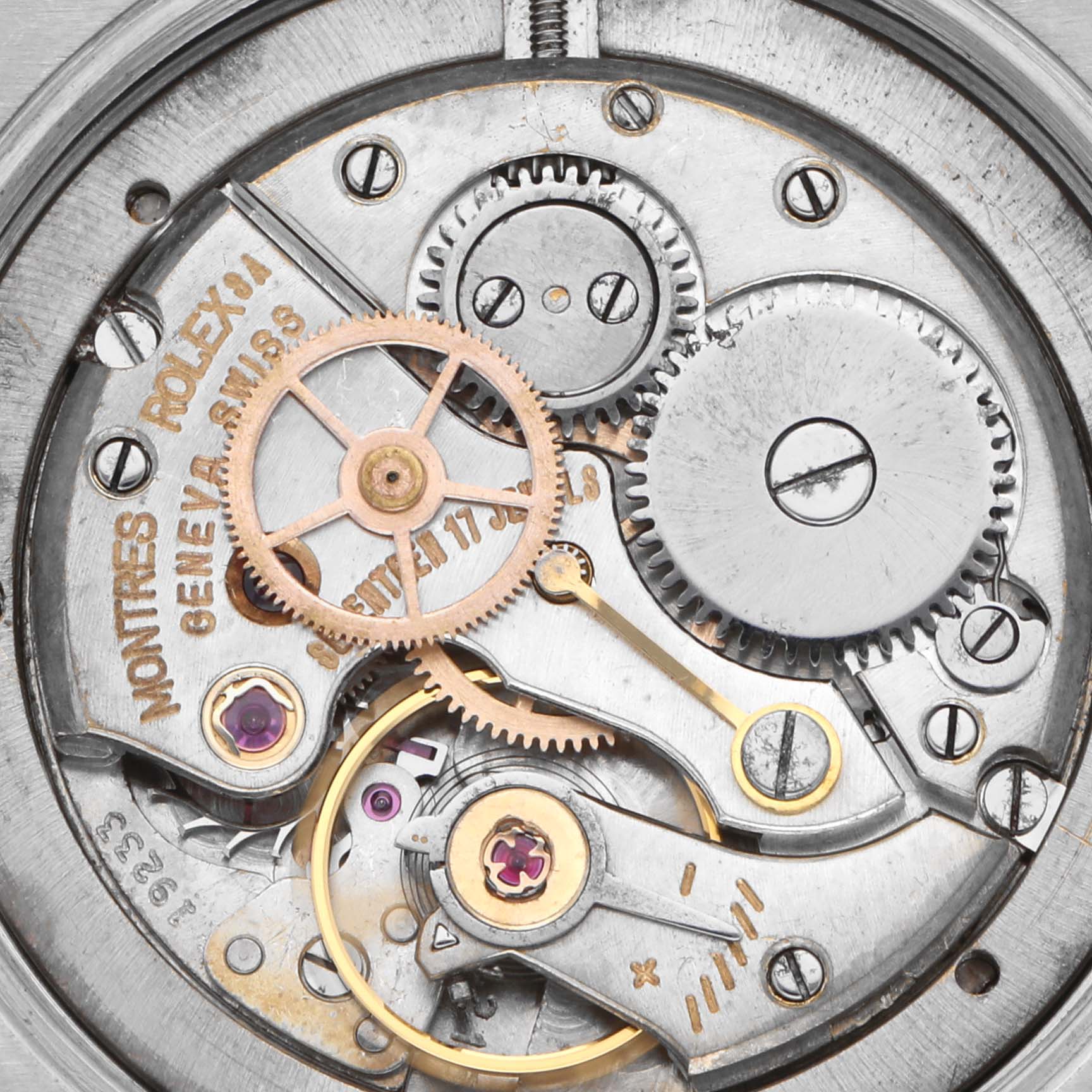 The image shows an inside view of the Rolex Date 6694 Men's Stainless Steel Silver Dial 6694 Men's Stainless Steel Silver Dial watch, focusing on its intricate movement gears and components.