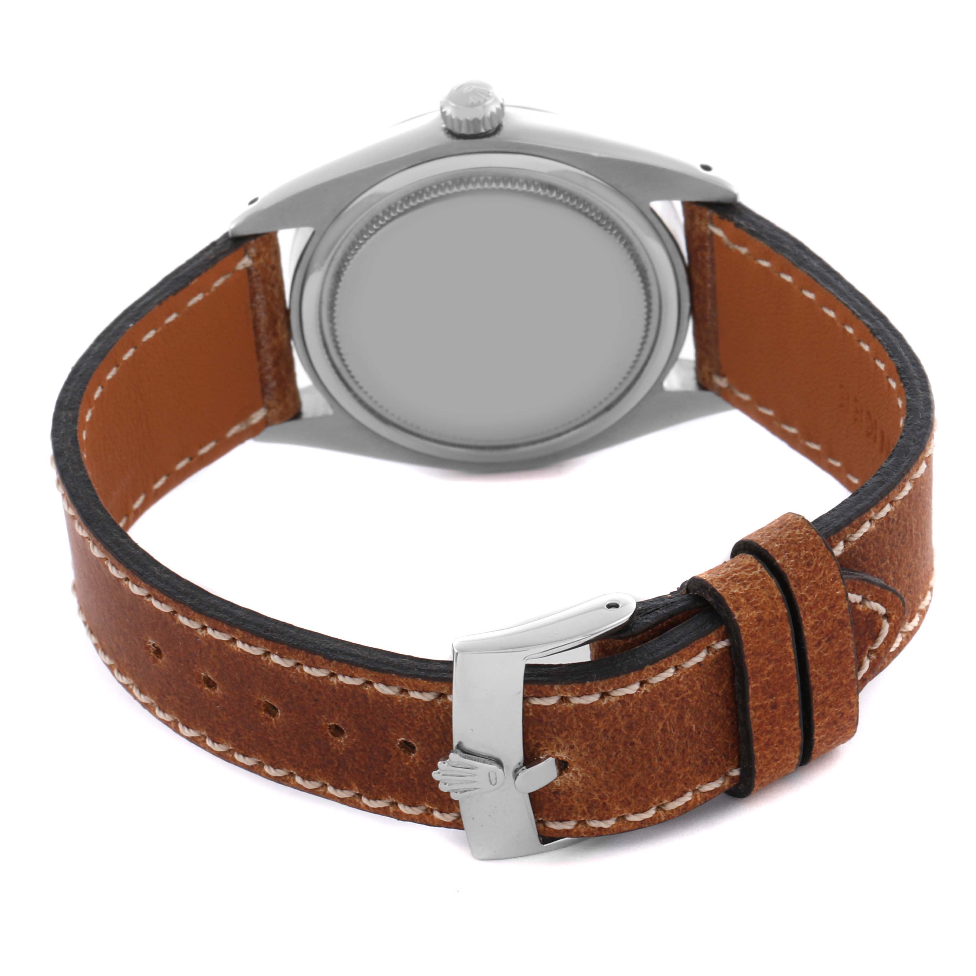 The Rolex Date 6694 Men's Stainless Steel Silver Dial 6694 Men's Stainless Steel Silver Dial watch is shown from the back, highlighting the case back, crown, and leather strap with buckle.