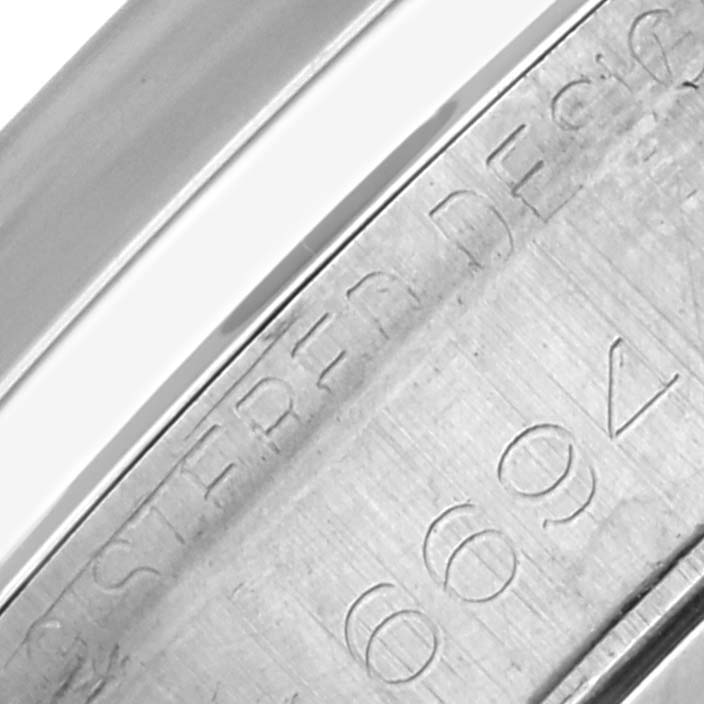The image shows an engraved section of the inner case of a Rolex Date 6694 Men's Stainless Steel Silver Dial 6694 Men's Stainless Steel Silver Dial watch.