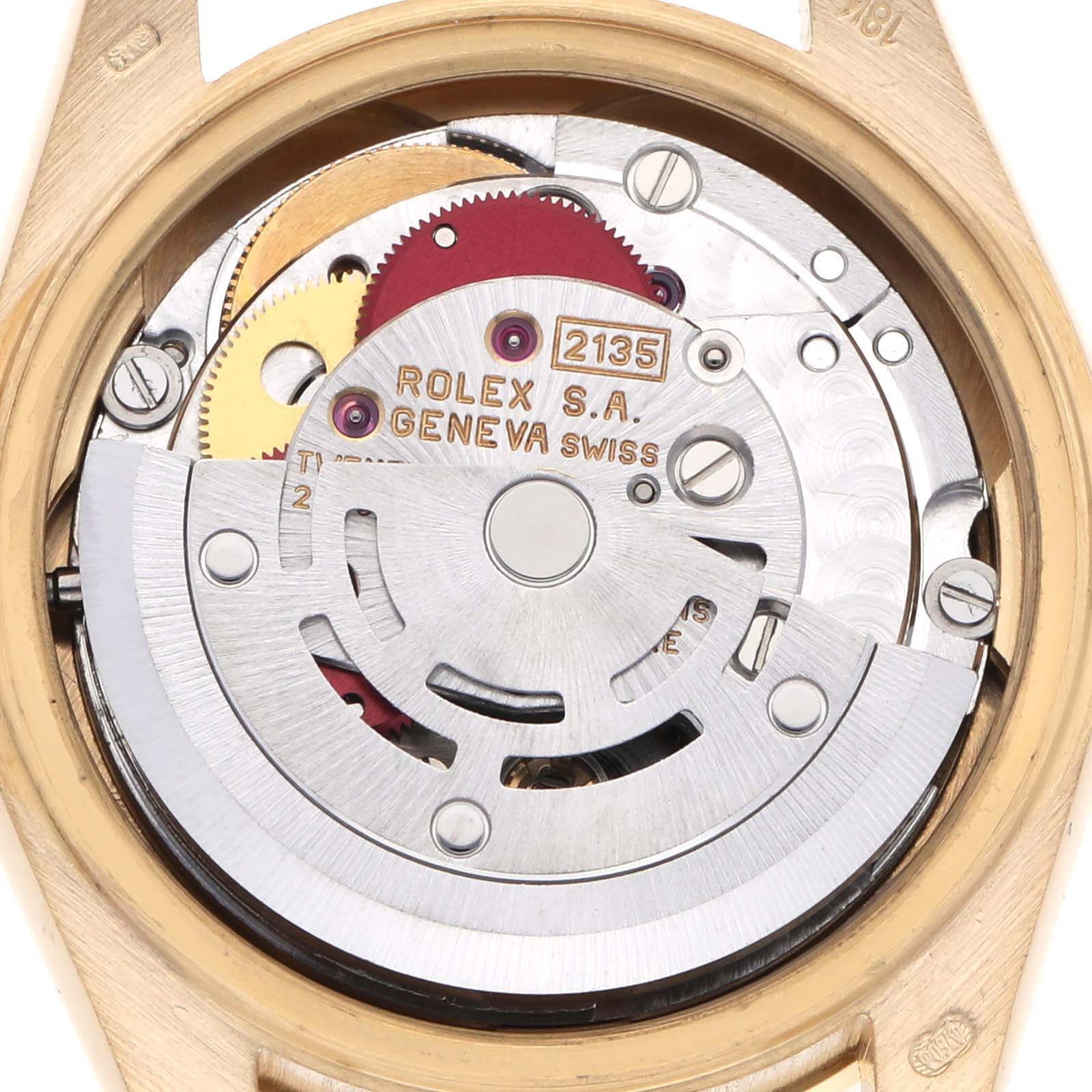 The image shows the inner mechanical movement of a Rolex President 69138 Women's Yellow Gold Champagne Dial 69138 Women's Yellow Gold Champagne Dial model, featuring gears and rotors from a top-down angle.