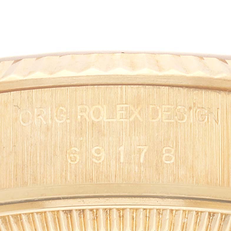 This image shows a close-up of the engraved side of the case of a Rolex President 69178 Women
s Yellow Gold Champagne Dial 69178 Women
s Yellow Gold Champagne Dial model watch.