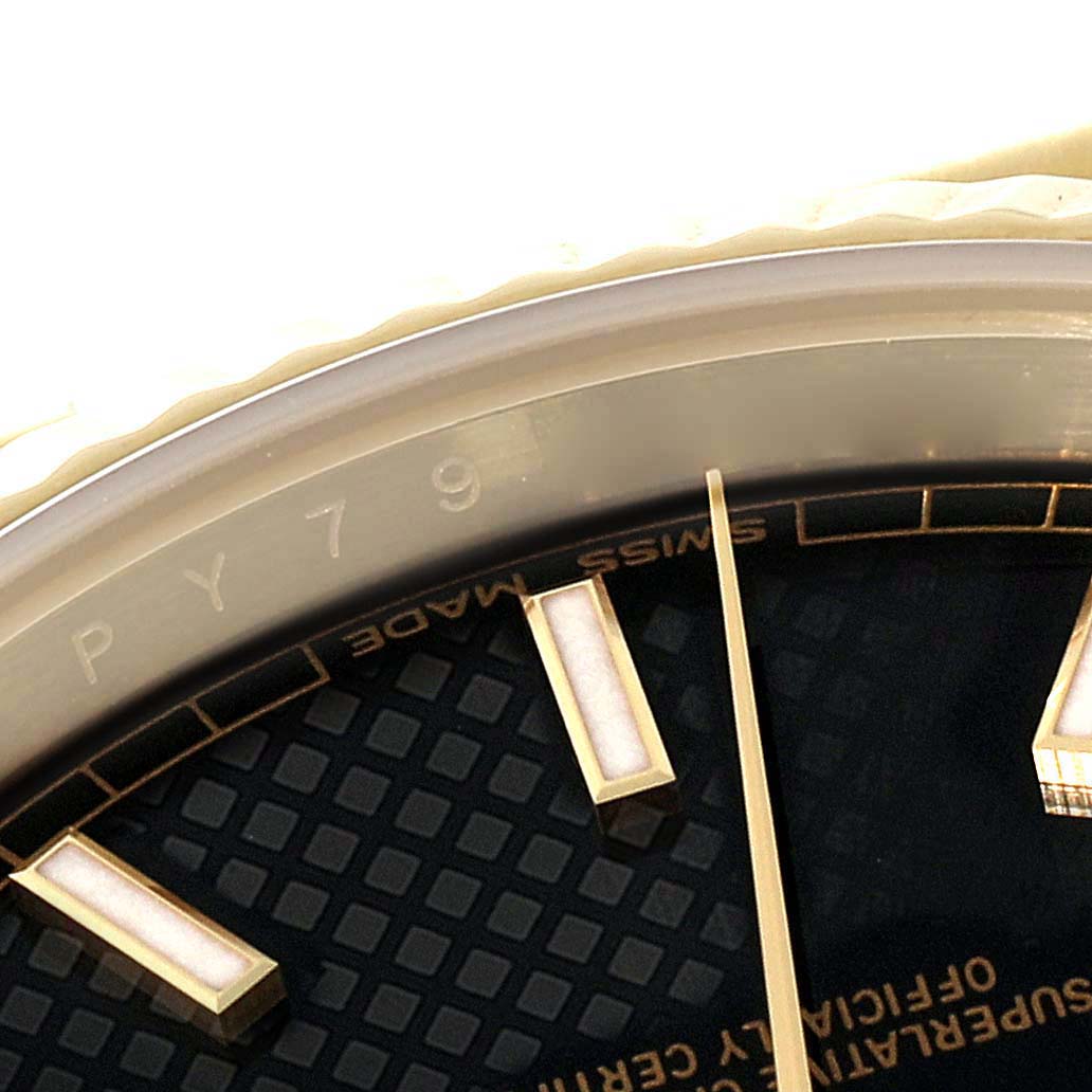 This image shows a close-up of the face and bezel of a Rolex President 228238 Men's Yellow Gold Black Dial 228238 Men's Yellow Gold Black Dial model watch, highlighting the markers and "Swiss Made" text.