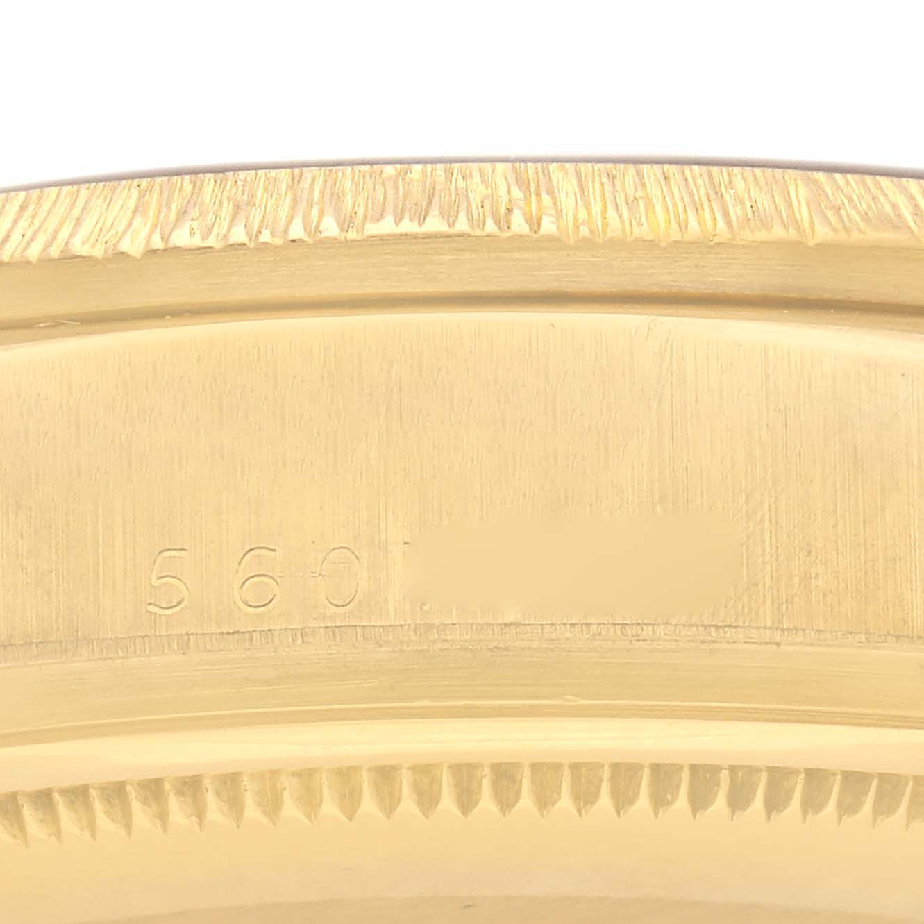 The image shows a close-up of the edge and serial number area on a Rolex President 18078 Men
s Yellow Gold Brown Dial 18078 Men
s Yellow Gold Brown Dial watch case.