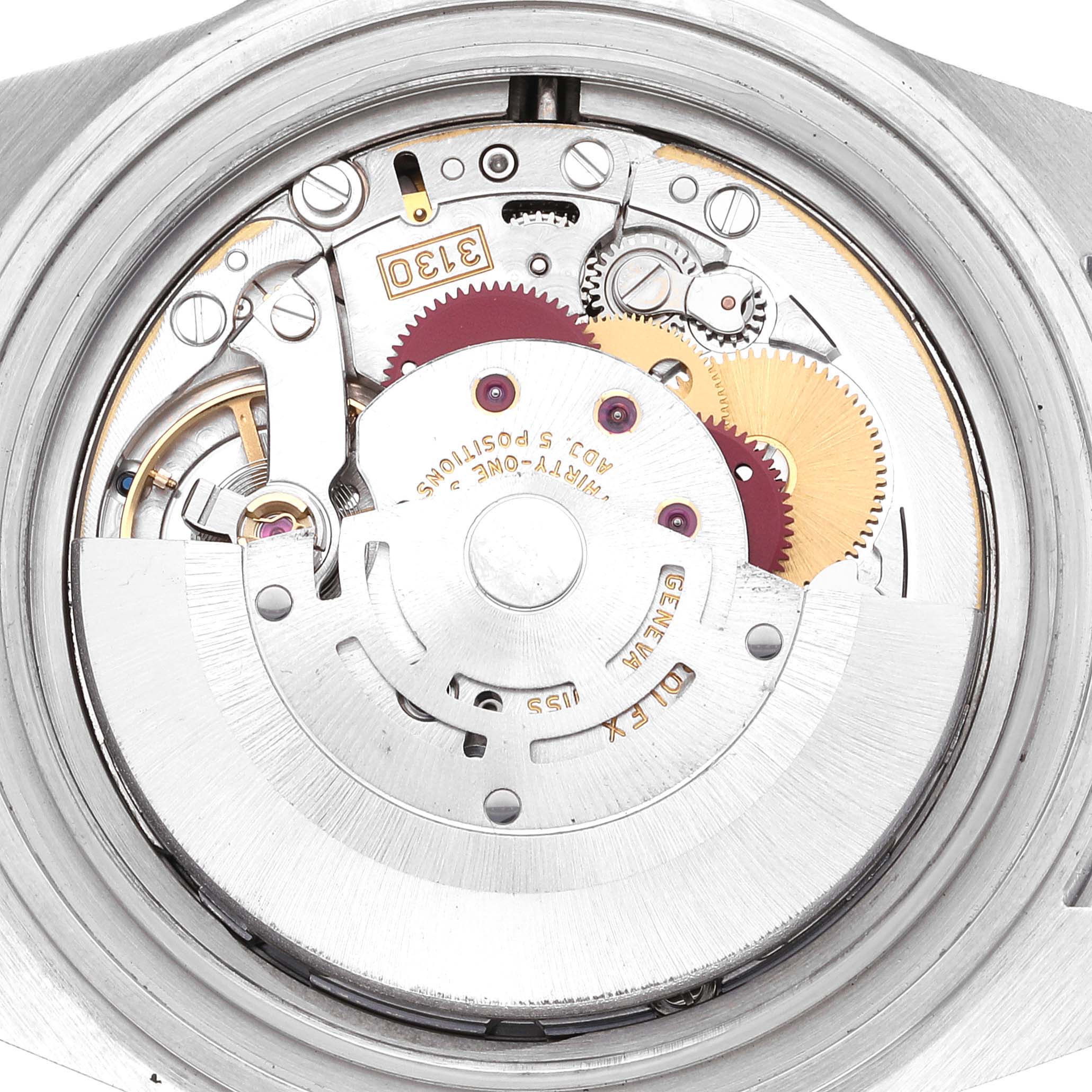 This image shows a close-up view of the movement of a Rolex Submariner 14060M Men
s Stainless Steel Black Dial 14060M Men
s Stainless Steel Black Dial watch with visible gears and components.