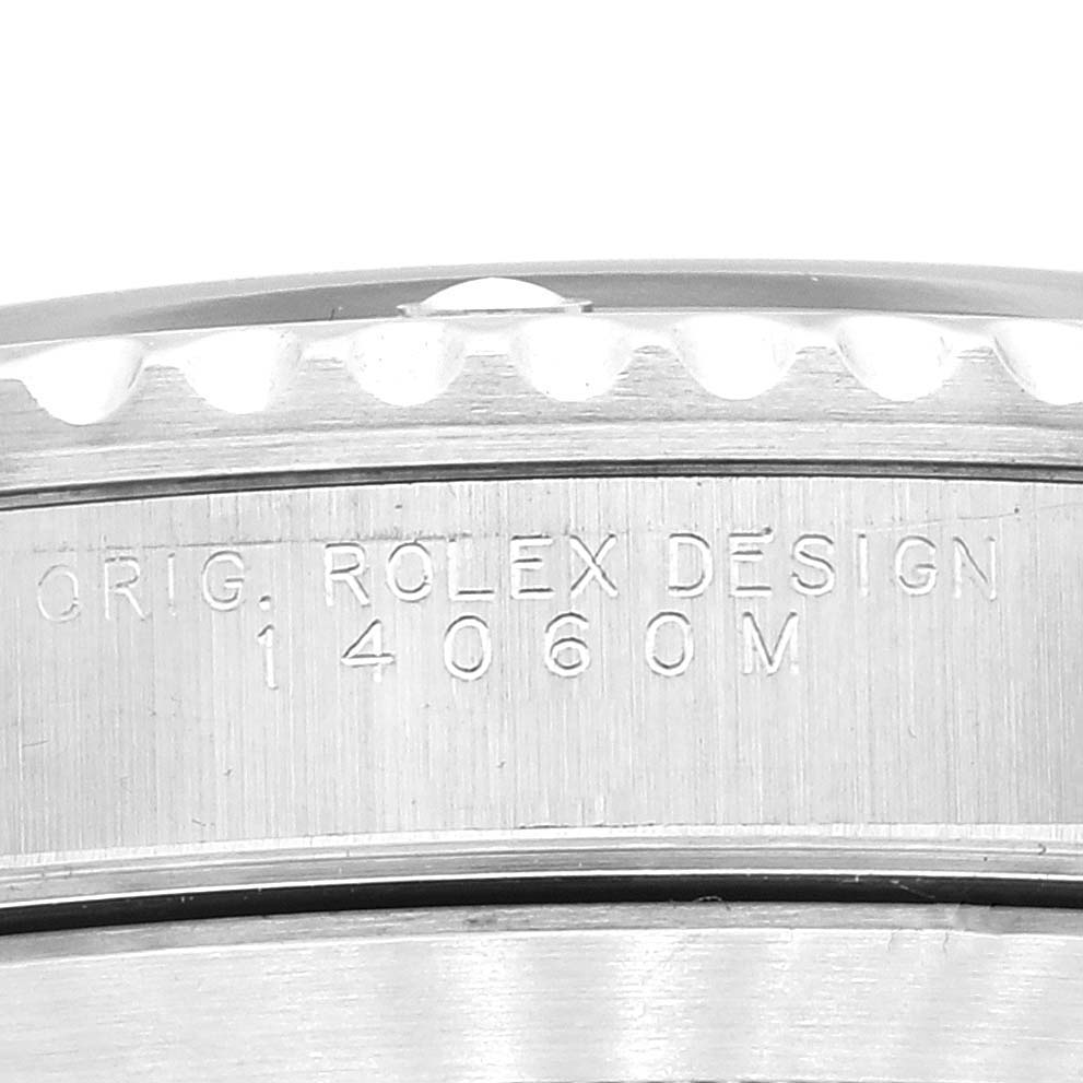 The image shows a close-up of the model number "14060M" engraved on the side of a Rolex Submariner 14060M Men
s Stainless Steel Black Dial 14060M Men
s Stainless Steel Black Dial watch case.