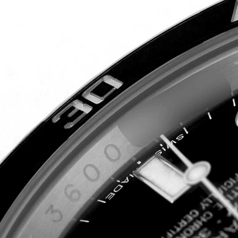 The image shows a close-up angle of the Rolex Submariner 114060 Men's Stainless Steel Black Dial's bezel and part of the dial with markers.