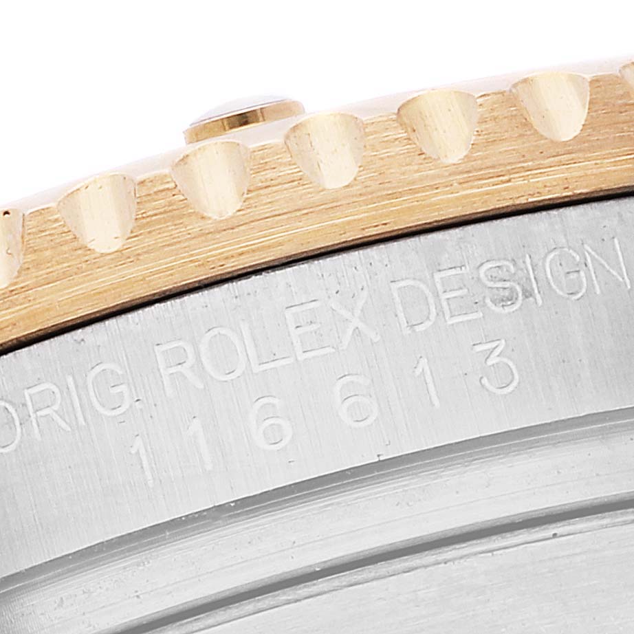 This image shows a close-up of the edge of the bezel and the case side of a Rolex Submariner 116613 Men's Steel and Gold (two tone) Black Dial 116613 Men's Steel and Gold (two tone) Black Dial watch.