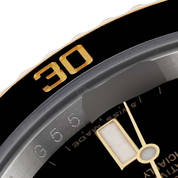 The image shows part of the bezel and dial of a Rolex Submariner 116613 Men's Steel and Gold (two tone) Black Dial 116613 Men's Steel and Gold (two tone) Black Dial watch, highlighting the "30" minute marker and a portion of the hour hand.