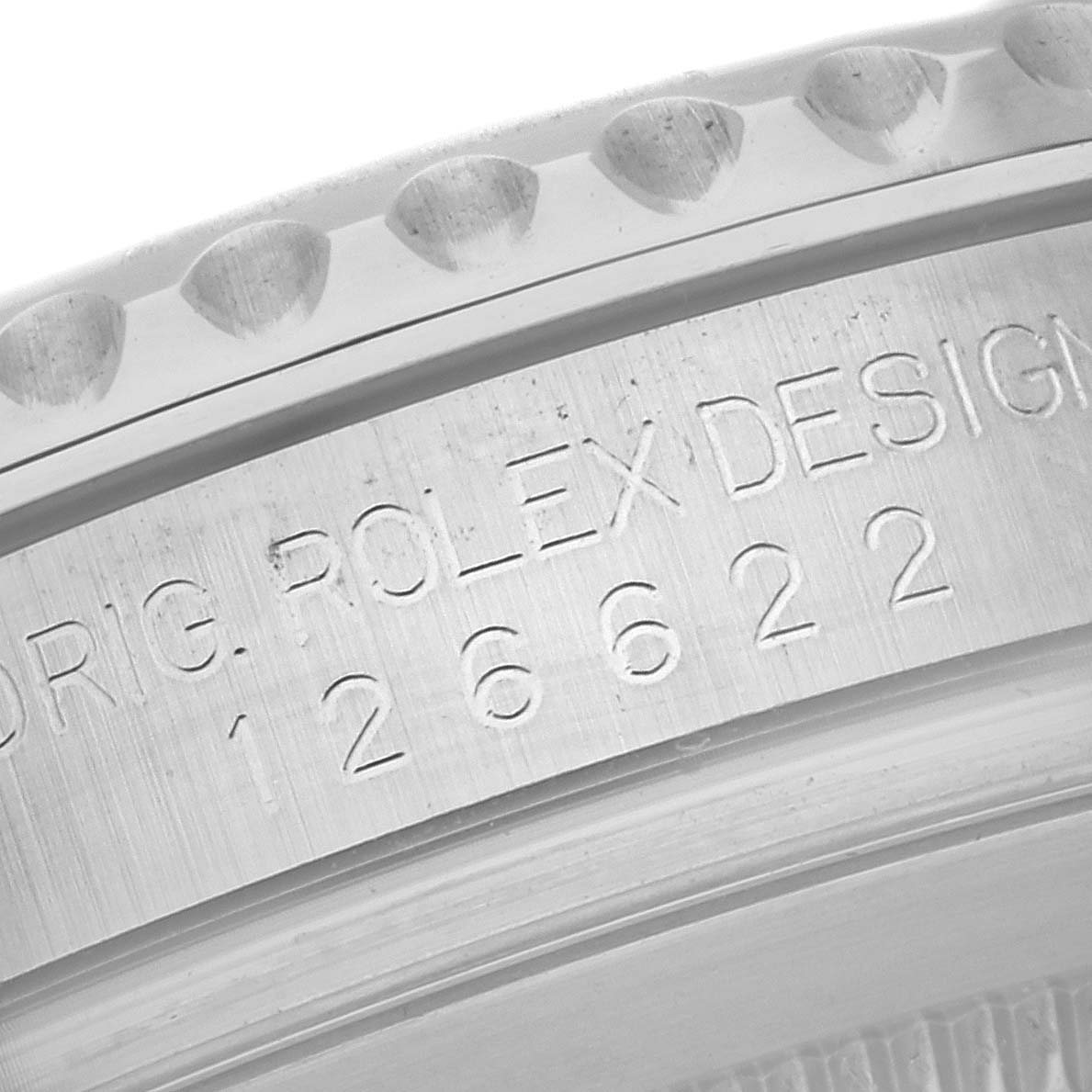 This close-up image shows the engraved serial number and part of the bezel of a Rolex Yacht-Master 126622 Men's Stainless Steel Grey Dial 126622 Men's Stainless Steel Grey Dial watch.