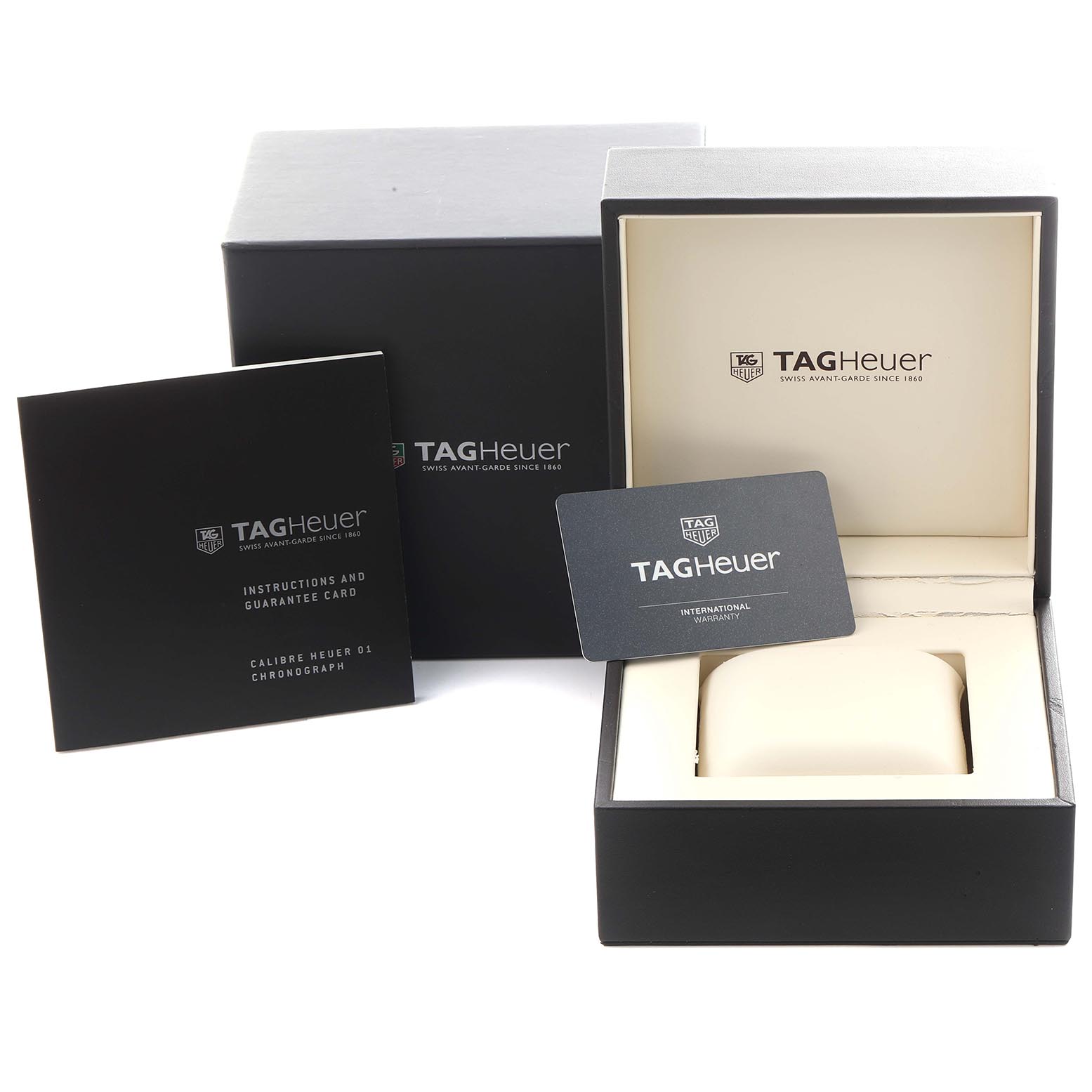 The image shows the Tag Heuer Carrera CAR201T.FC6406 Men
s Stainless Steel Blue Dial CAR201T.FC6406 Men
s Stainless Steel Blue Dial watch box, instruction booklet, and warranty card at a slightly elevated angle.