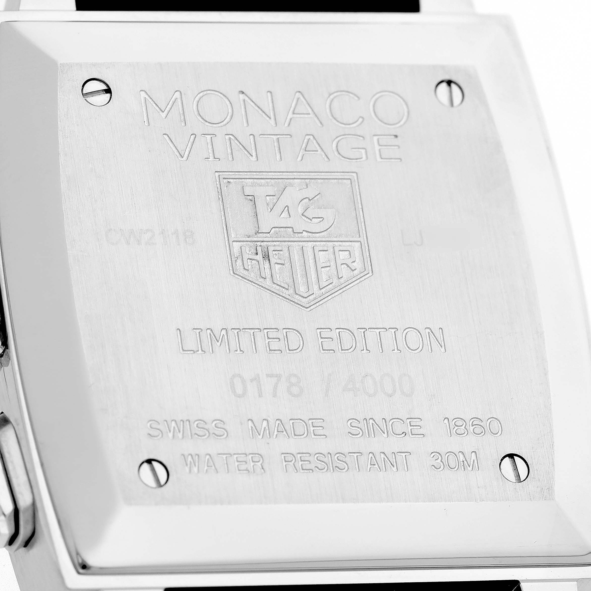 The image shows the back of the Tag Heuer Monaco Vintage Limited Edition watch, displaying engravings and screws.