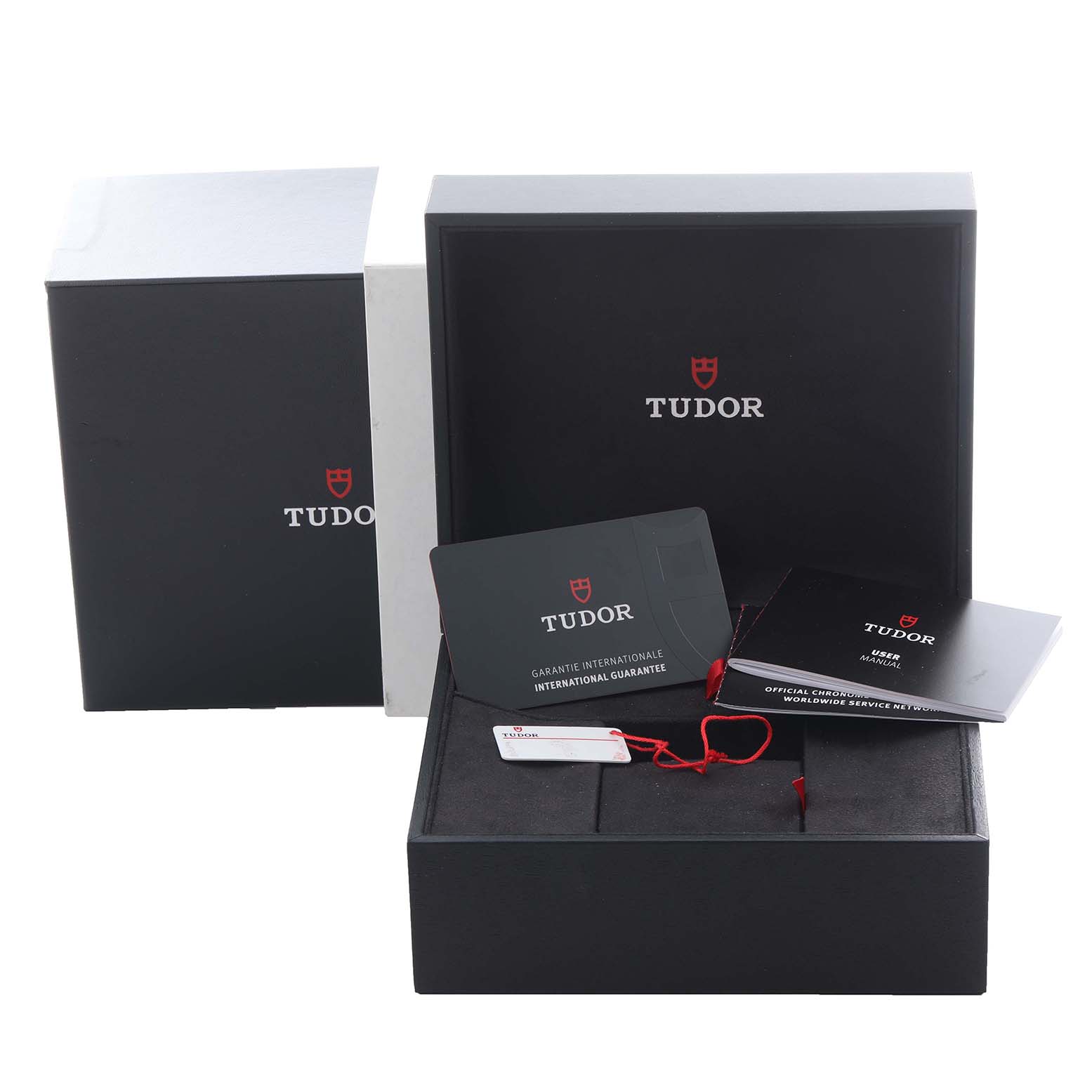 This image shows the packaging and accessories for the Tudor Heritage Black Bay 79360N Men's Stainless Steel Silver Dial 79360N Men's Stainless Steel Silver Dial, including a box, warranty card, and manuals.