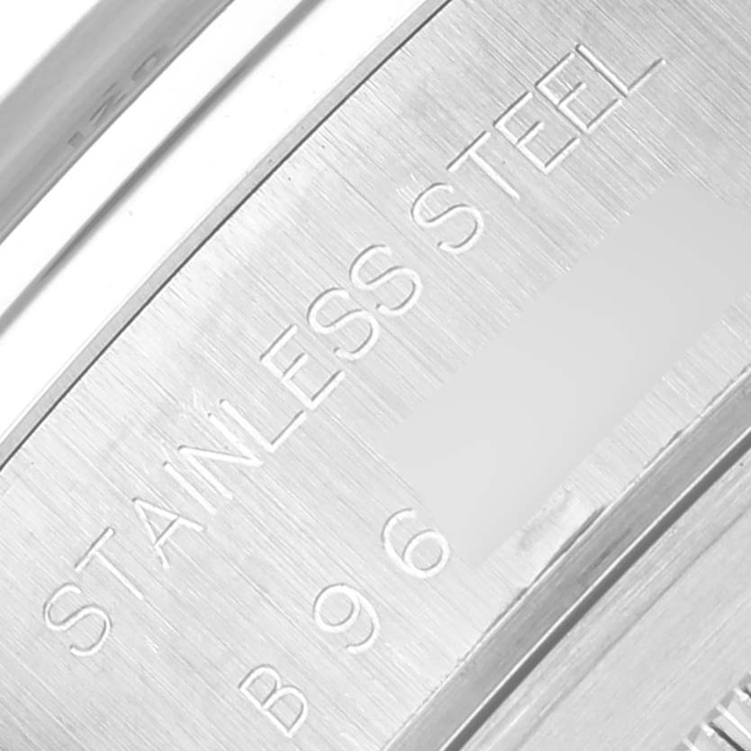 The image shows a close-up of the caseback edge detailing "STAINLESS STEEL" on the Tudor Tiger 79280 Men's Stainless Steel Red Dial 79280 Men's Stainless Steel Red Dial model watch.