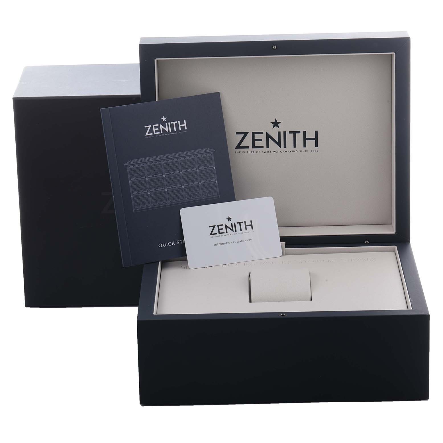 The image shows the Zenith Chronomaster 03.3120.3600/76.M3100 Men
s Stainless Steel Silver Dial 03.3120.3600/76.M3100 Men
s Stainless Steel Silver Dial box, an open manual, and a warranty card.