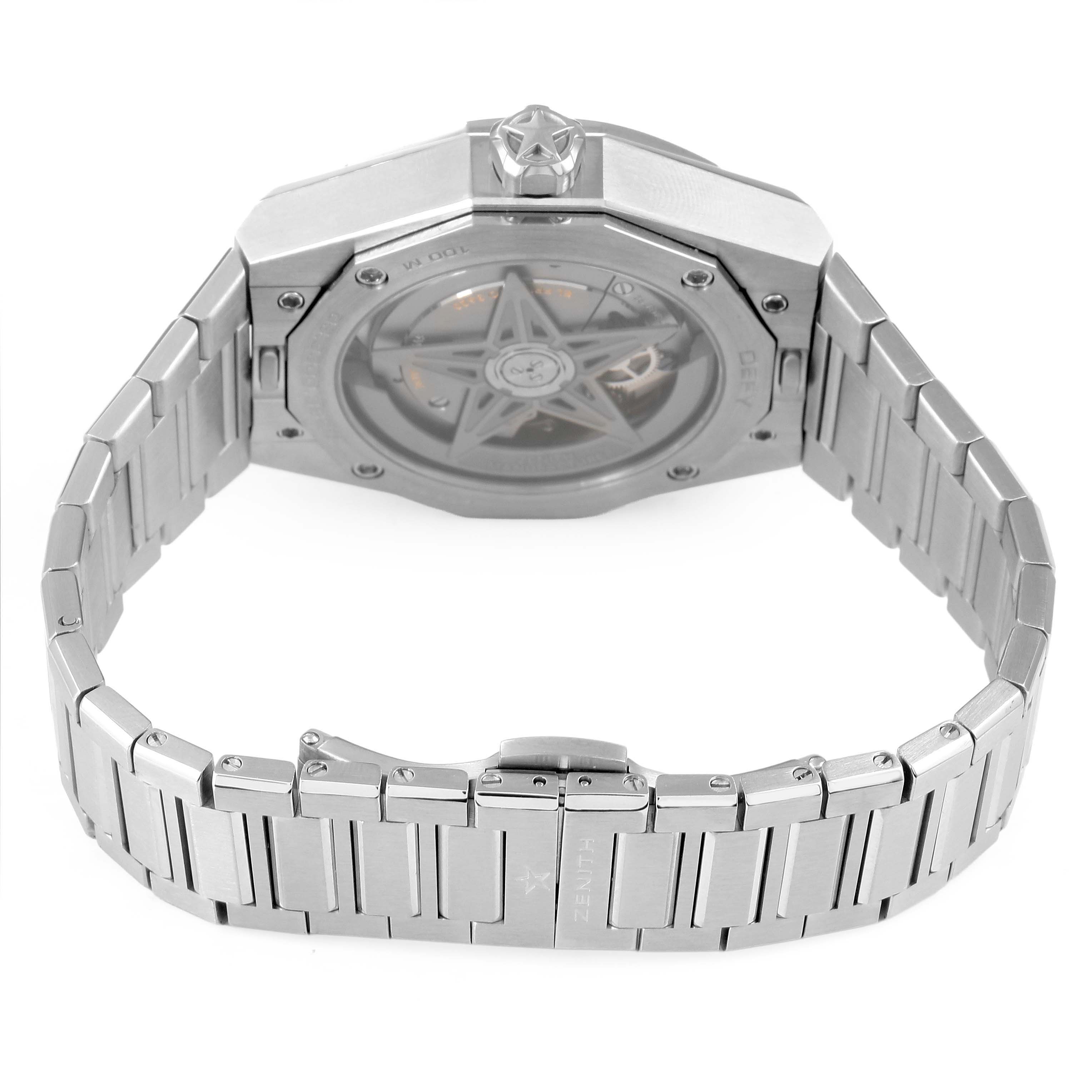 The image shows the Zenith Defy 03.9300.3620 Men's Stainless Steel Blue Dial model from the back, highlighting the display case back and metal bracelet.