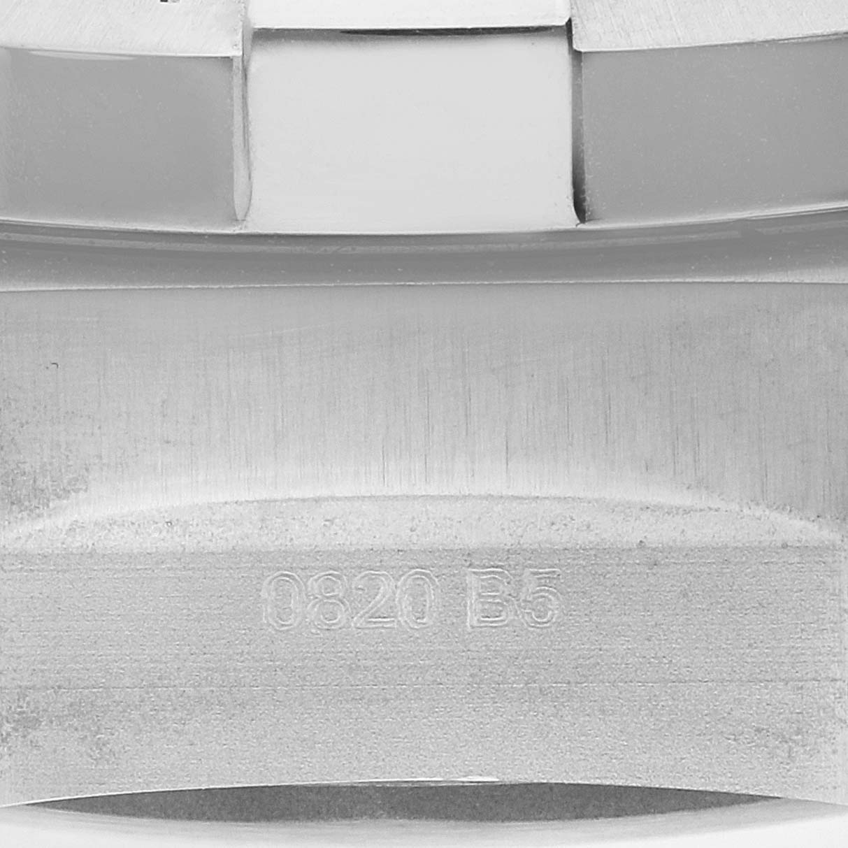 This close-up image shows the engraved part of the stainless steel band of a Breitling Avenger A17319 Men's Stainless Steel Yellow Dial A17319 Men's Stainless Steel Yellow Dial watch.