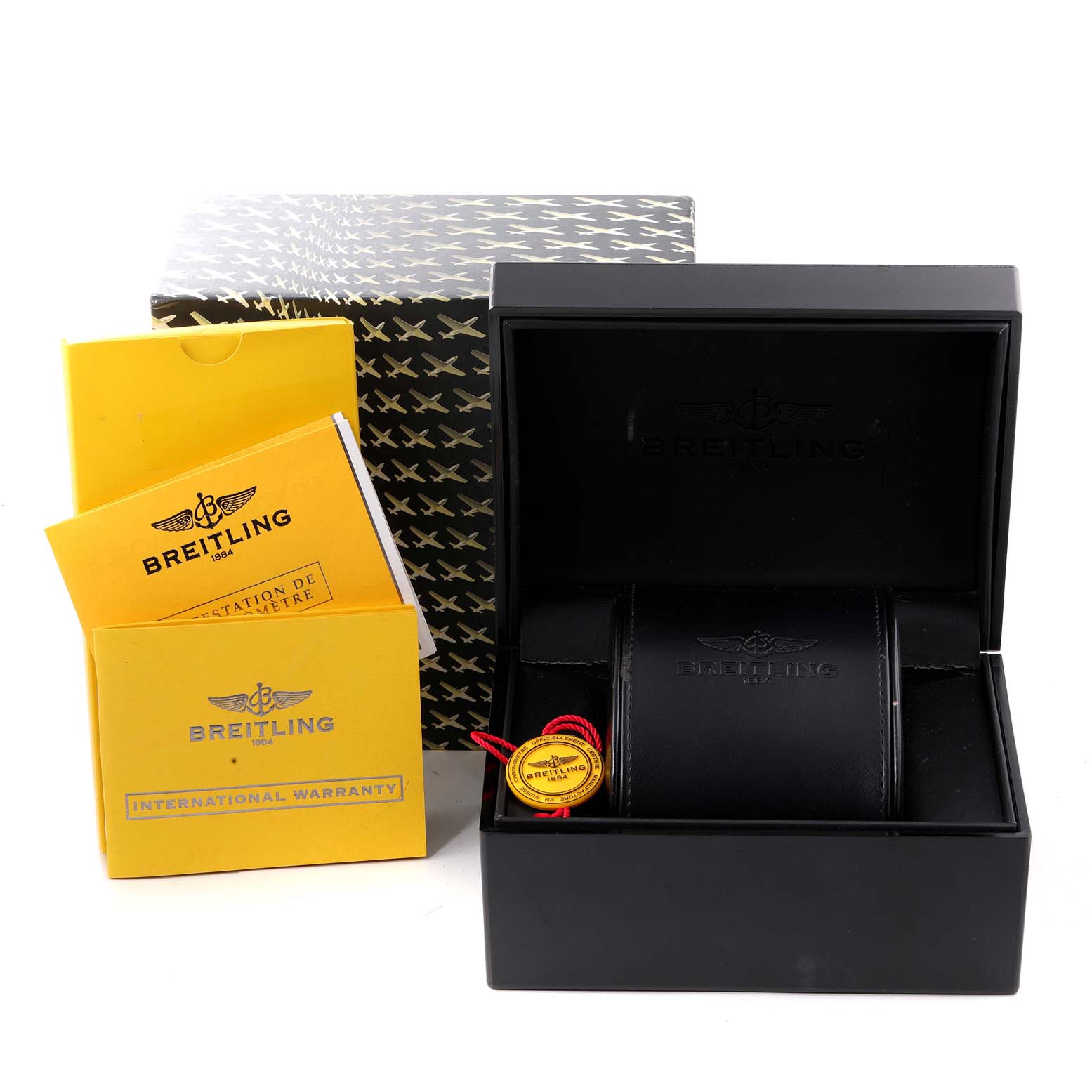 The image shows the packaging and accessories of a Breitling Avenger A73390 Men's Stainless Steel Blue Dial A73390 Men's Stainless Steel Blue Dial watch, including the box, manuals, and warranty card.