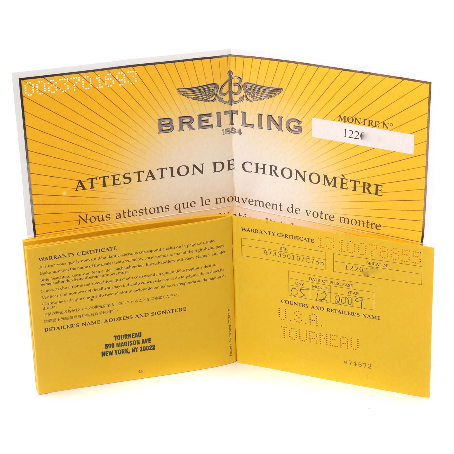 The image shows a Breitling Avenger A73390 Men's Stainless Steel Blue Dial A73390 Men's Stainless Steel Blue Dial warranty certificate and chronometer attestation documents viewed from an angle.