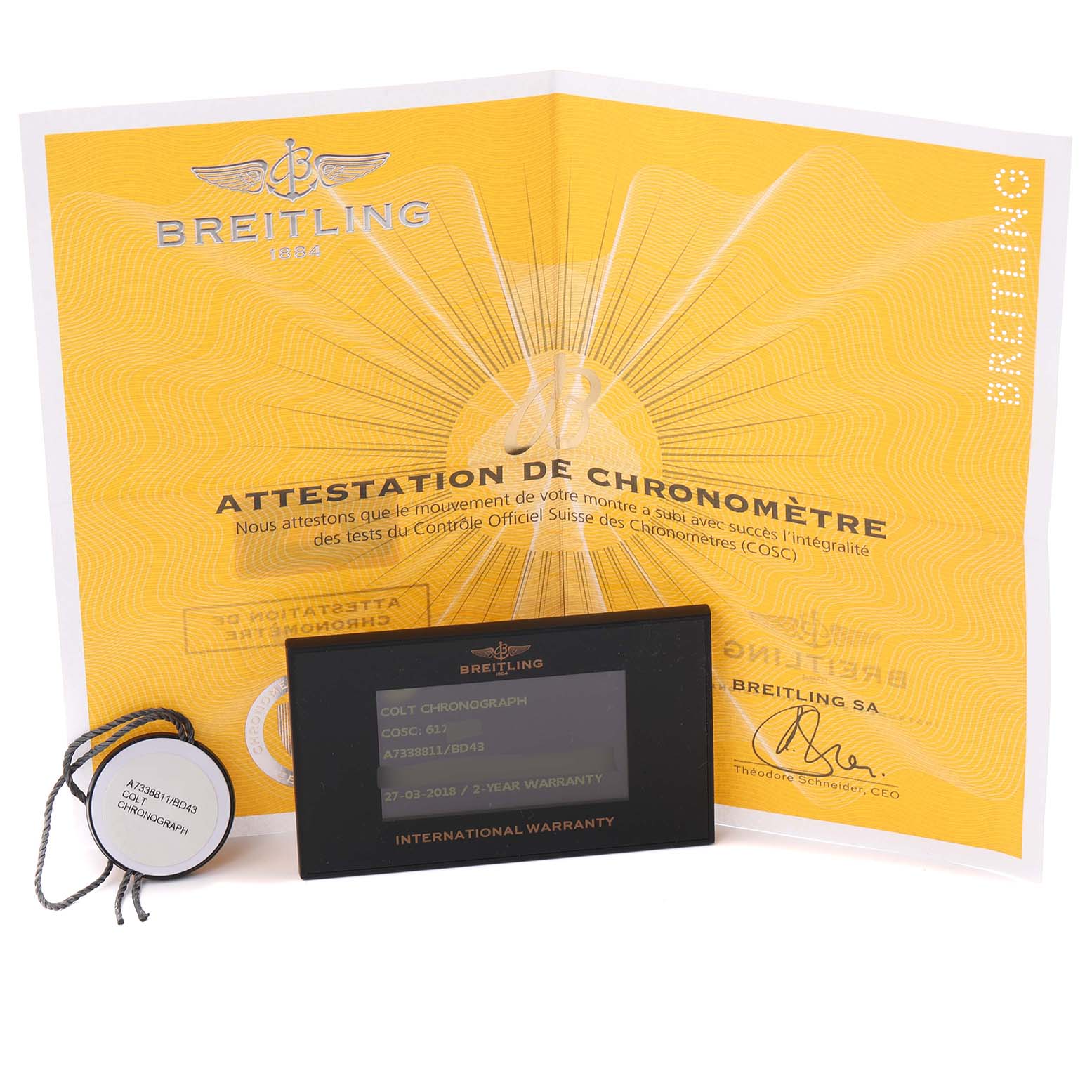 The image shows Breitling Colt A7338811/BD43 Men's Stainless Steel Black Dial A7338811/BD43 Men's Stainless Steel Black Dial model documentation including a yellow chronometer certificate, a hang tag, and an international warranty card.
