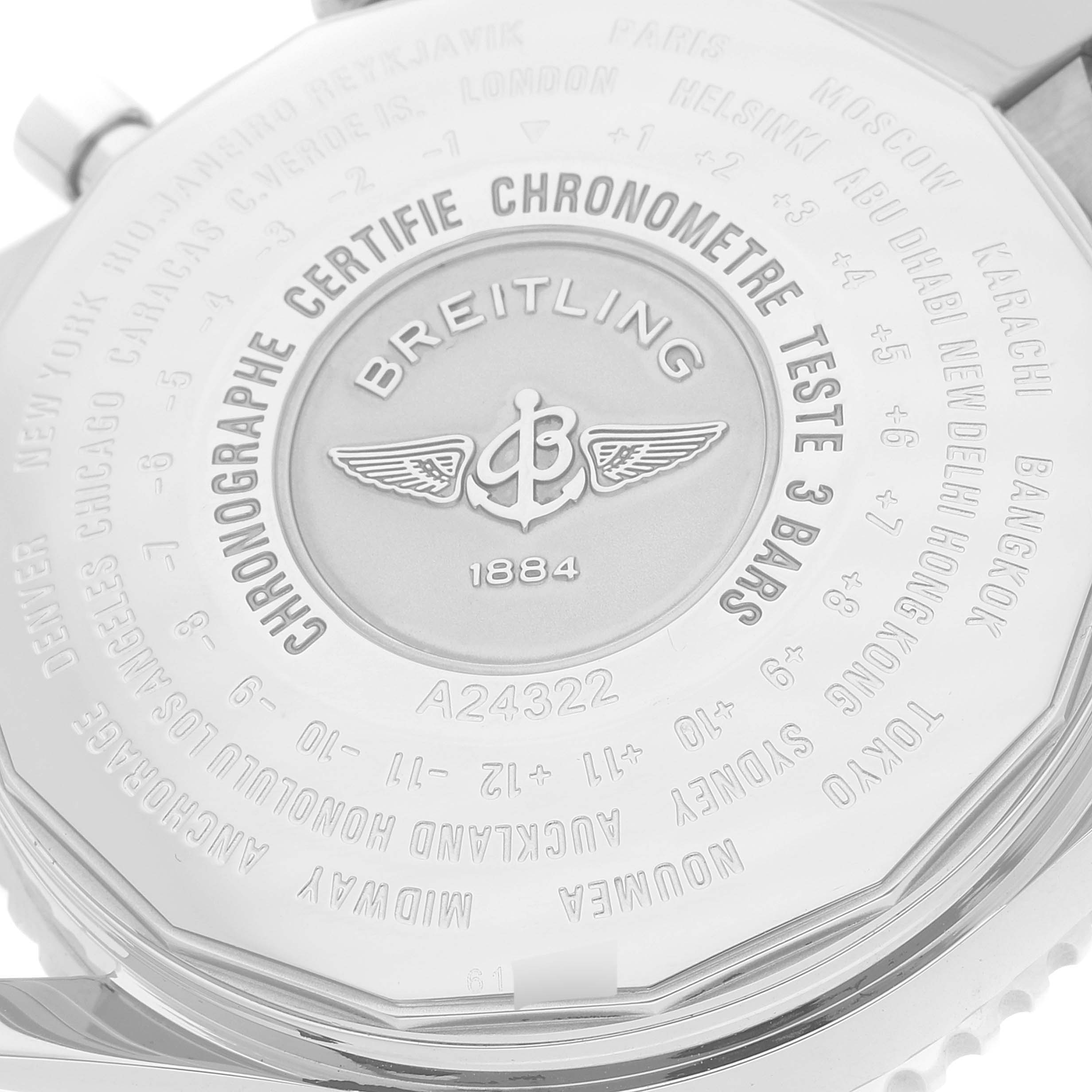 This image shows the case back of a Breitling Navitimer A24322 Men's Stainless Steel Silver Dial A24322 Men's Stainless Steel Silver Dial, displaying the brand logo, certification details, and various time zones.