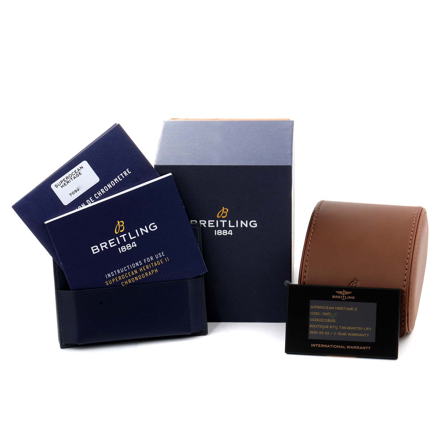 The image shows accessories for the Breitling Superocean U1331312/BG50/279S/A20D.4 Men's Steel and Gold (two tone) Black Dial U1331312/BG50/279S/A20D.4 Men's Steel and Gold (two tone) Black Dial model, including instruction booklets, a box, a leather case, and a warranty card.