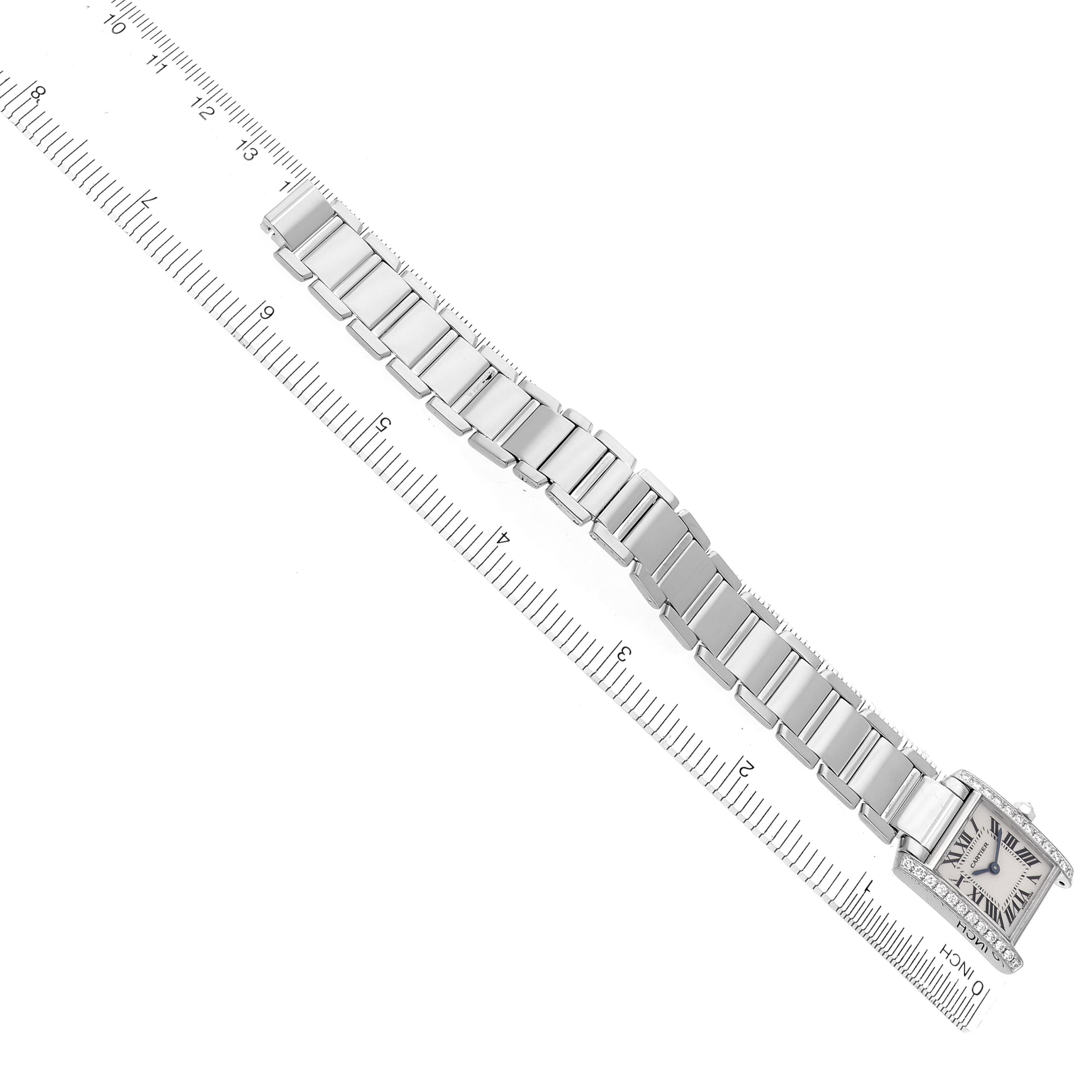 The Cartier Tank Francaise WE1002S3 Women's White Gold Silver Dial WE1002S3 Women's White Gold Silver Dial watch is displayed diagonally, showing the full bracelet and face from an overhead angle, accompanied by a ruler.