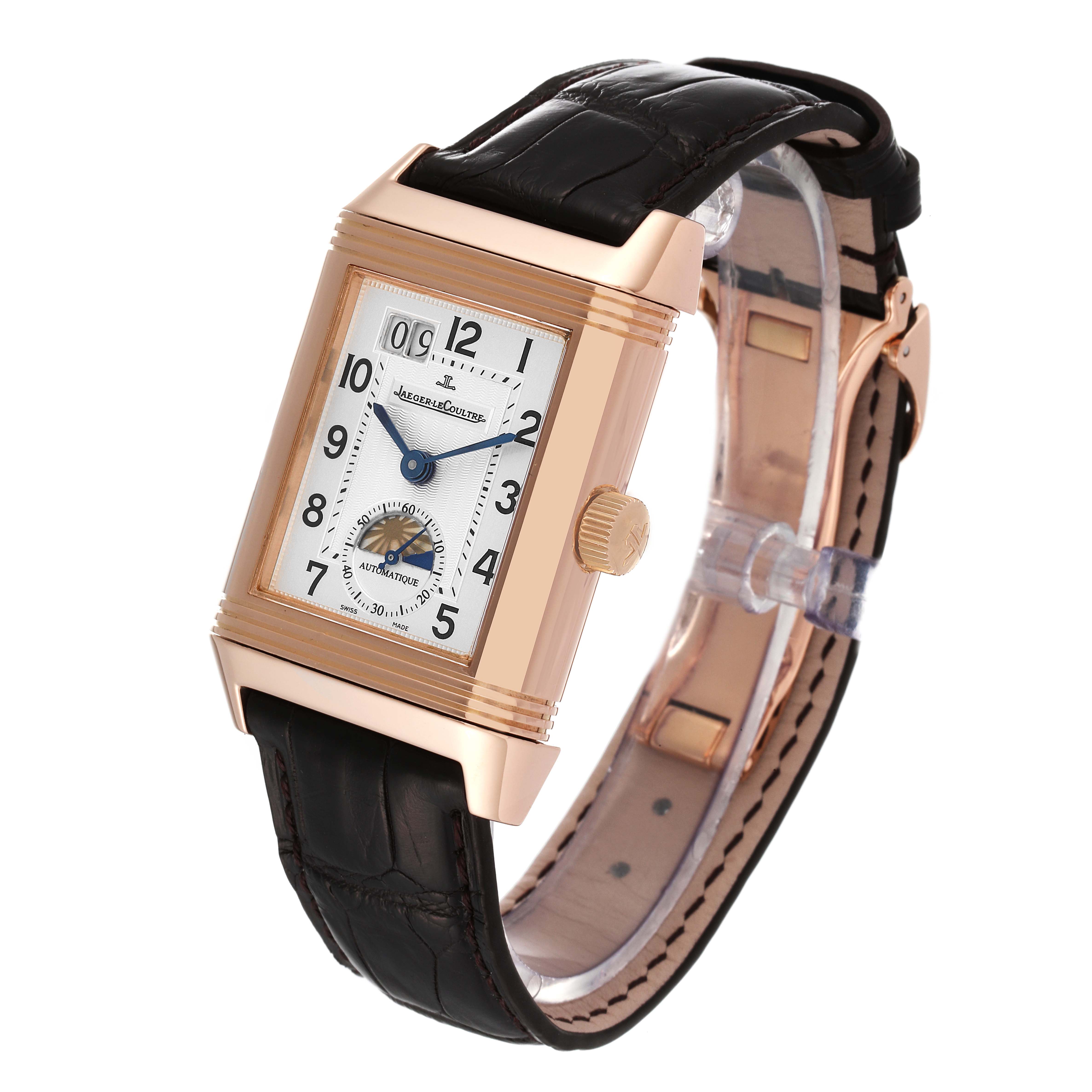 The image shows a Jaeger LeCoultre Reverso Q3032420 Men
s Rose Gold Silver Dial Q3032420 Men
s Rose Gold Silver Dial watch, angled from the front and side, displaying its dial, crown, and leather strap.
