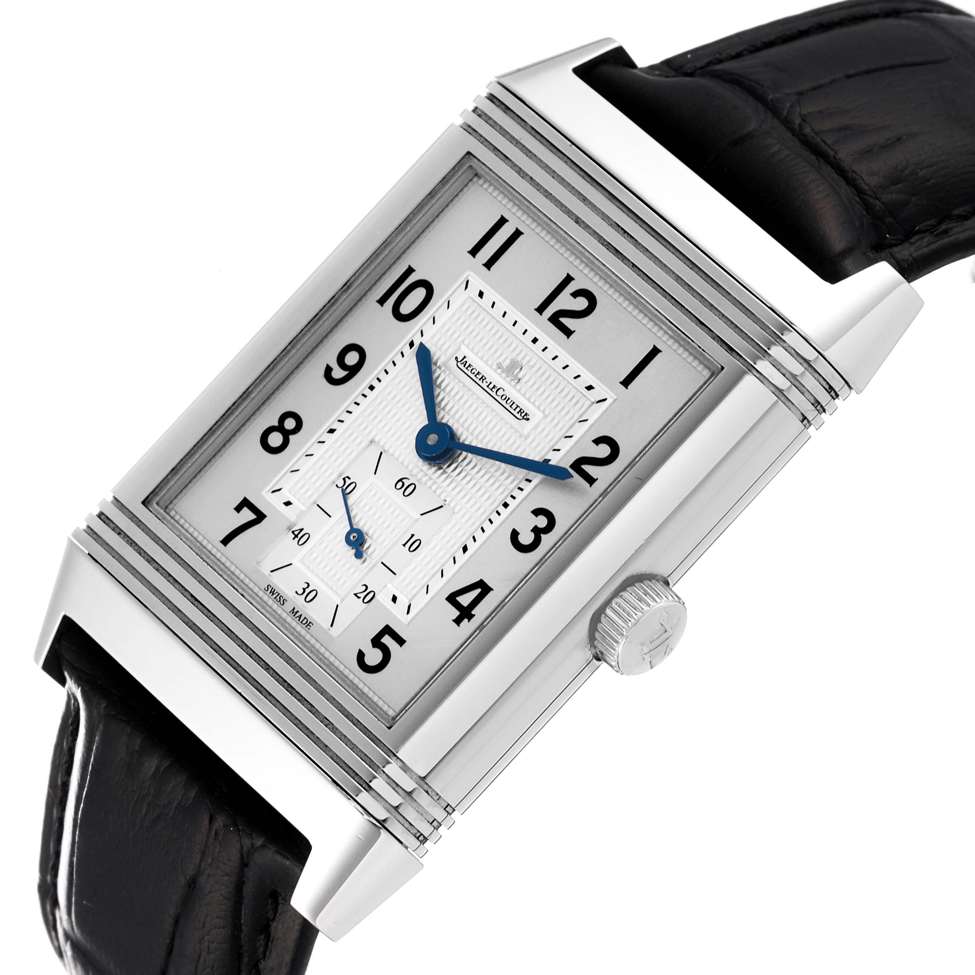 The Jaeger-LeCoultre Reverso watch is shown from an angled top-down view, highlighting the dial, case, crown, and part of the strap.