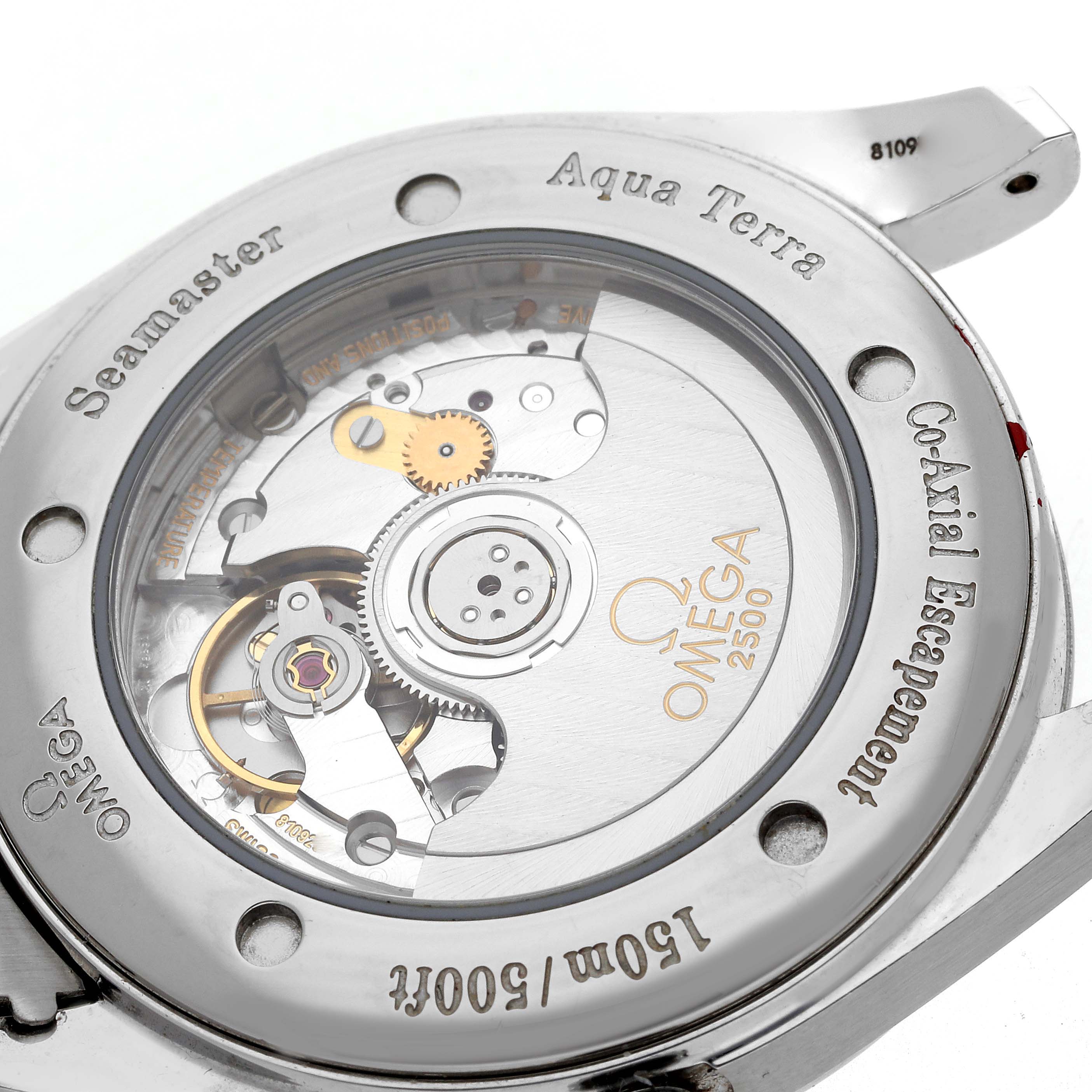 The image shows the back of an Omega Aqua Terra 2503.60.00 Men
s Stainless Steel Red Dial 2503.60.00 Men
s Stainless Steel Red Dial watch, revealing its movement and engraving details.