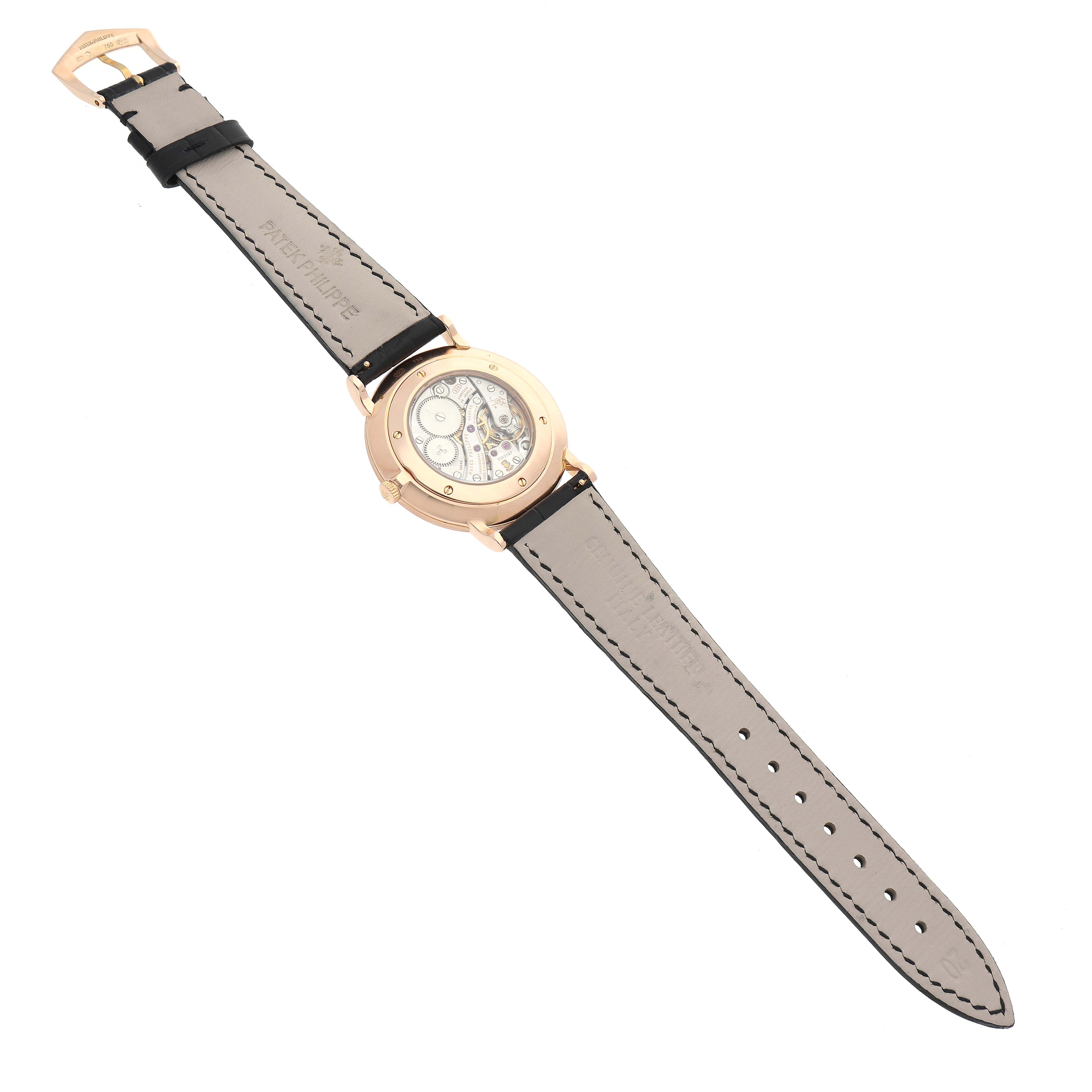 The image shows the back view of a Patek Philippe Calatrava 5119R-001 Men's Rose Gold White Dial 5119R-001 Men's Rose Gold White Dial watch, highlighting its transparent case back and leather strap.