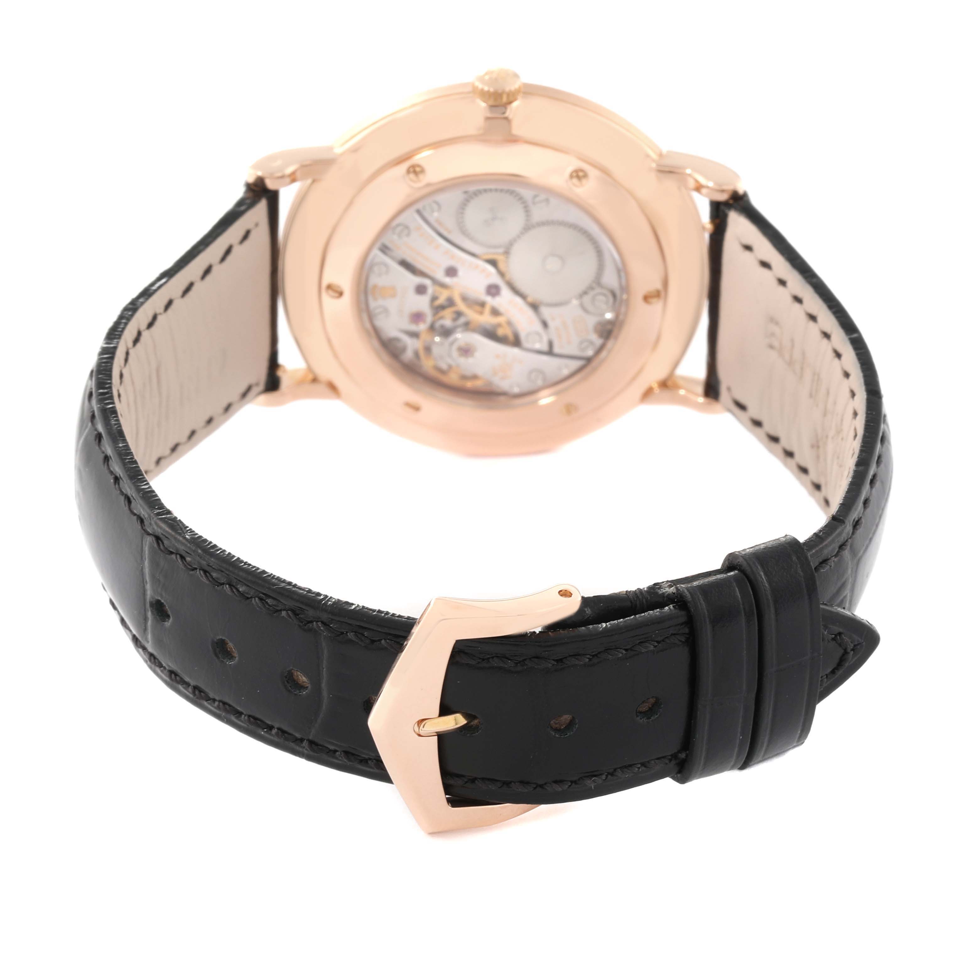 This image shows the back view of a Patek Philippe Calatrava 5119R-001 Men's Rose Gold White Dial 5119R-001 Men's Rose Gold White Dial watch, highlighting the movement through the caseback and the leather strap with a buckle.