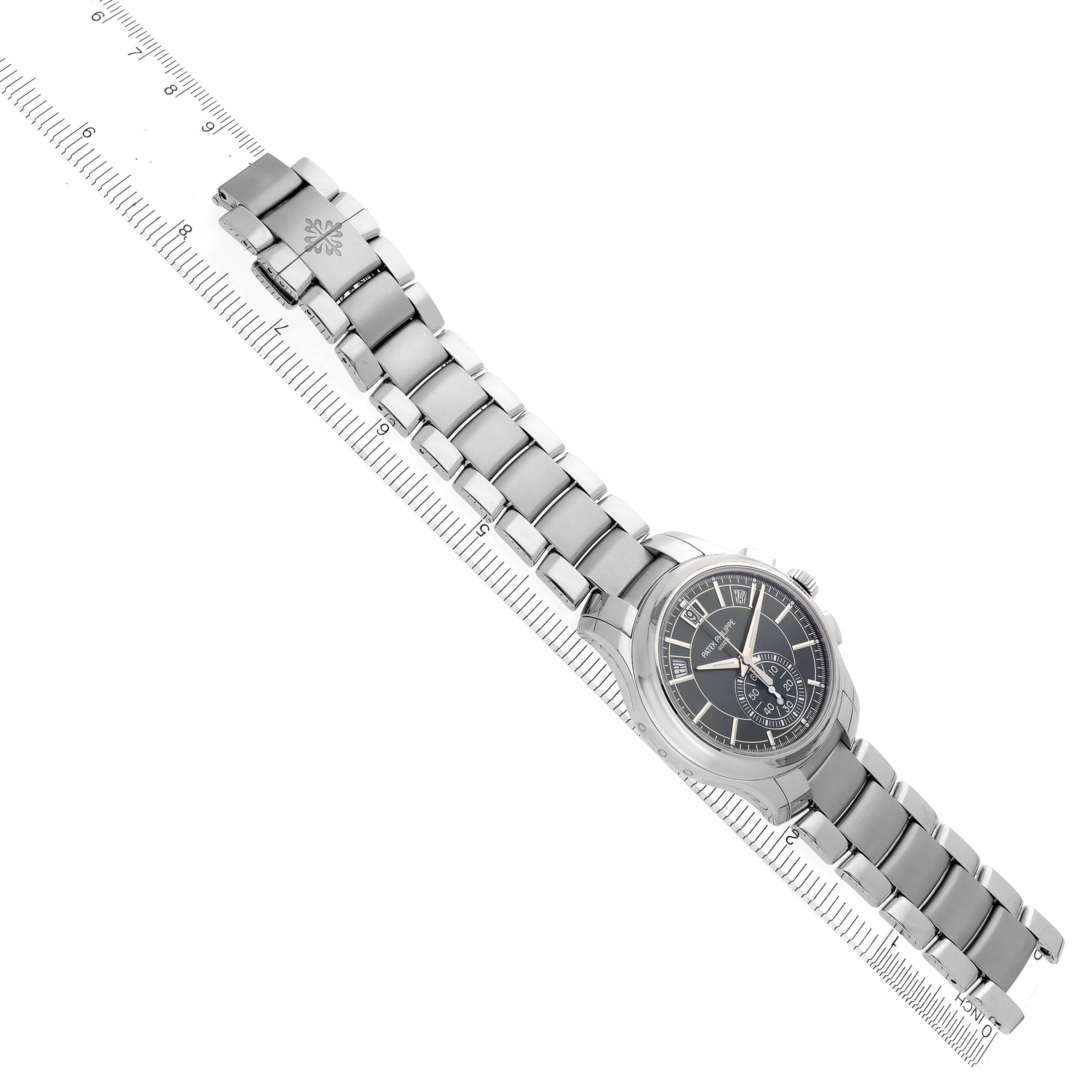 The Patek Philippe Complications 5905/1A-001 Men's Stainless Steel Green Dial 5905/1A-001 Men's Stainless Steel Green Dial watch is shown from a top angle, displaying the face, bracelet, and clasp alongside a ruler.