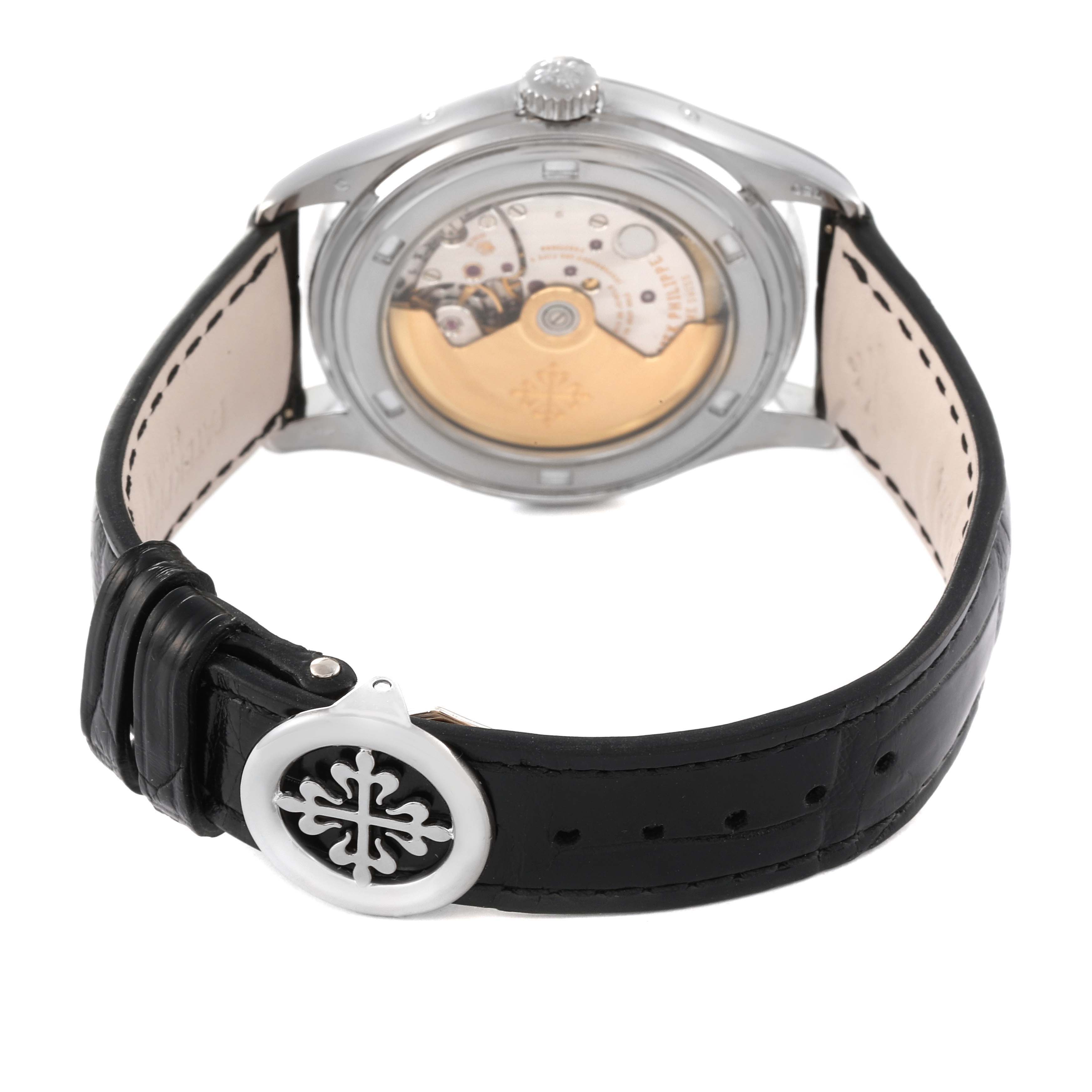 This image shows the back view of a Patek Philippe Complications 5146G Men's White Gold Beige Dial 5146G Men's White Gold Beige Dial watch, highlighting its movement and leather strap with a branded clasp.