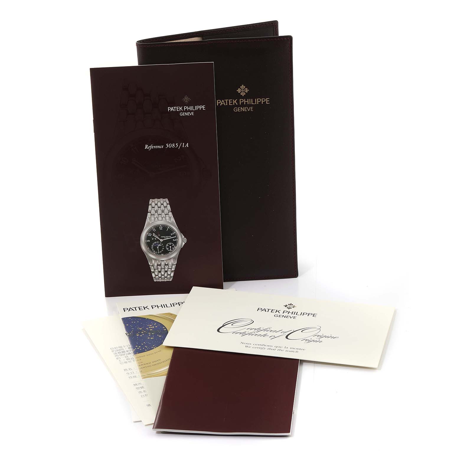 The image shows documentation and accessories for the Patek Philippe Neptune 5085/1A-001 Men
s Stainless Steel Black Dial 5085/1A-001 Men
s Stainless Steel Black Dial model watch, including booklets and certificates.