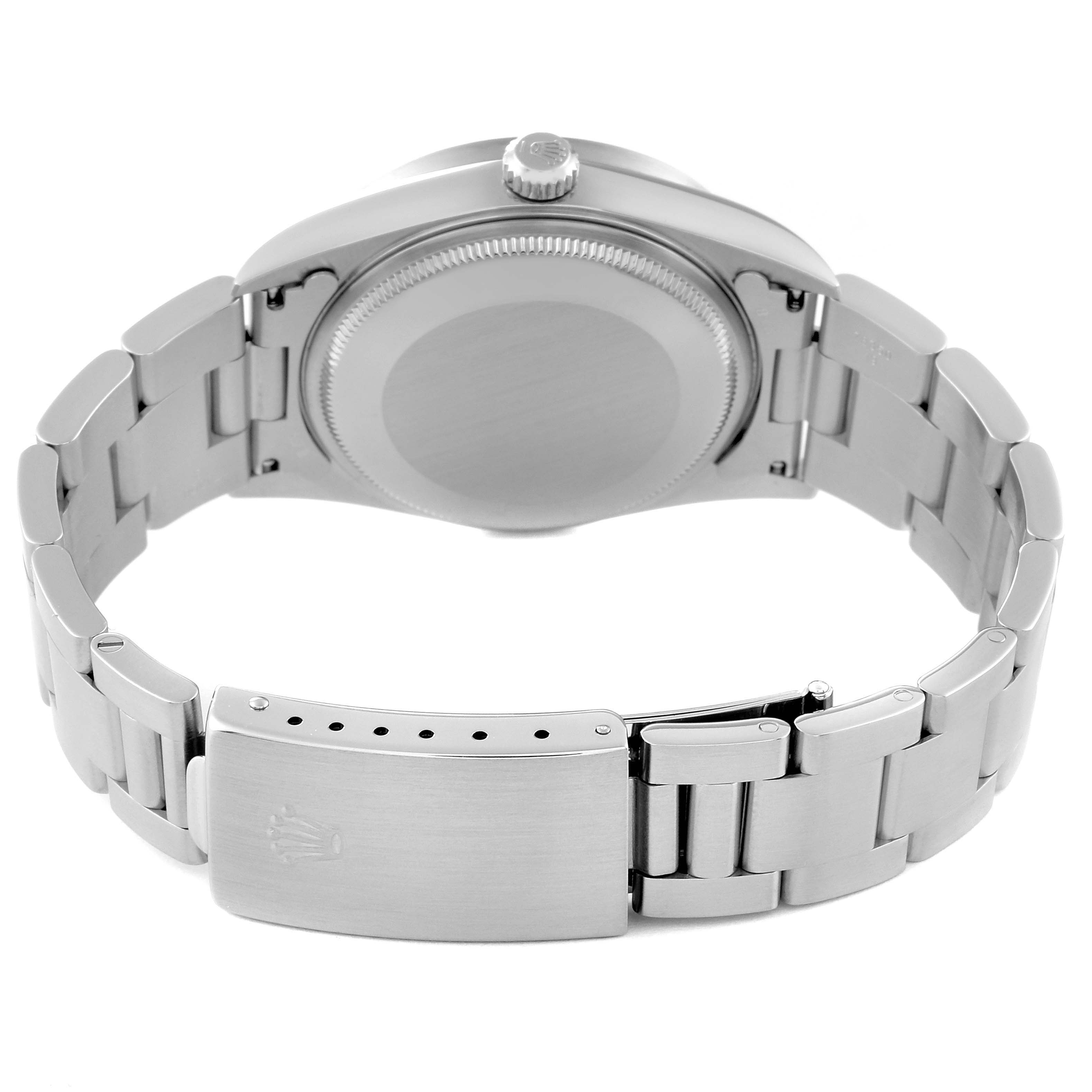 The image shows the back view of the Air-King watch by Rolex, highlighting its case, crown, and stainless steel bracelet clasp.