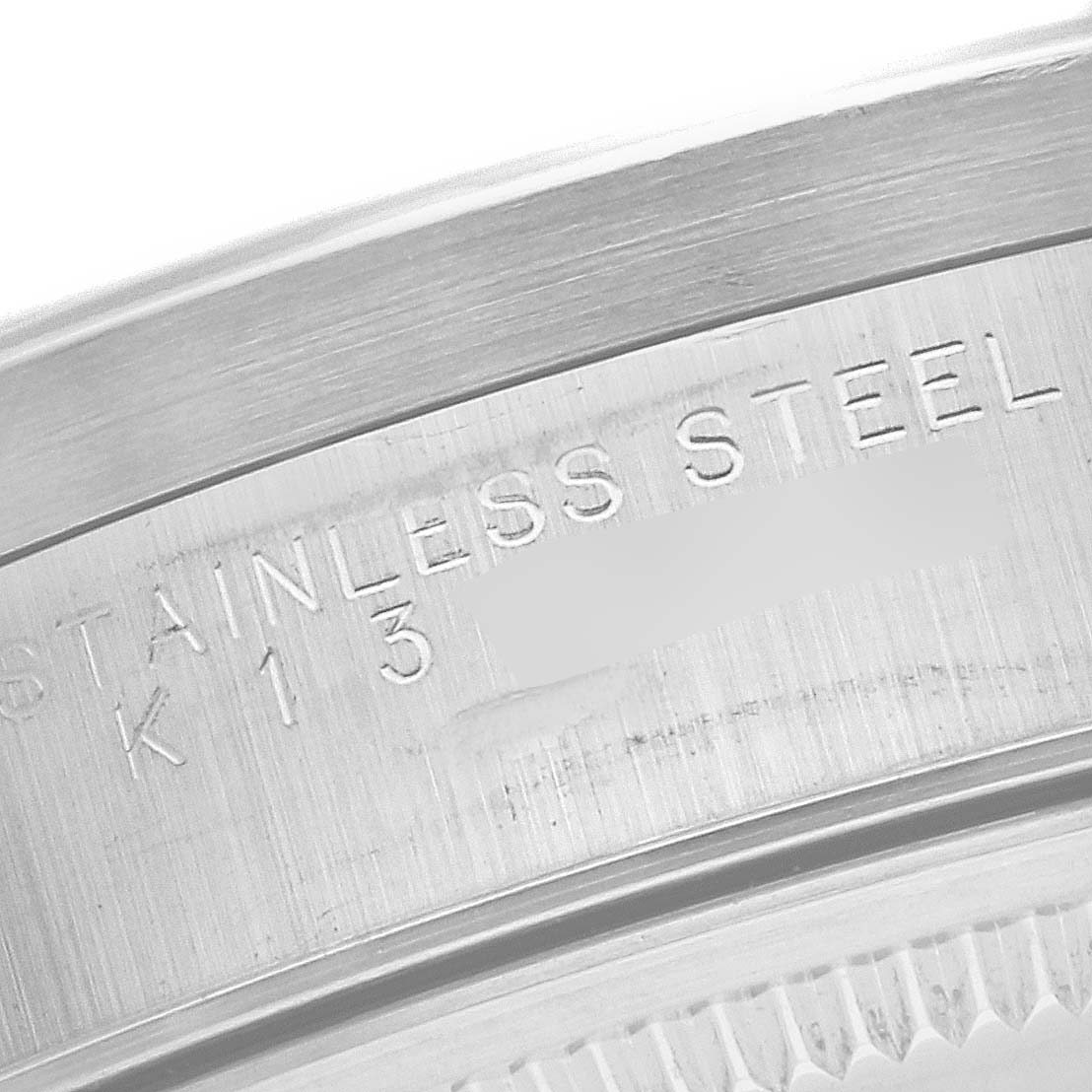 This close-up image shows the engraving on the side of the stainless steel case of a Rolex Air-King 14010 Men's Stainless Steel Black Dial 14010 Men's Stainless Steel Black Dial watch.