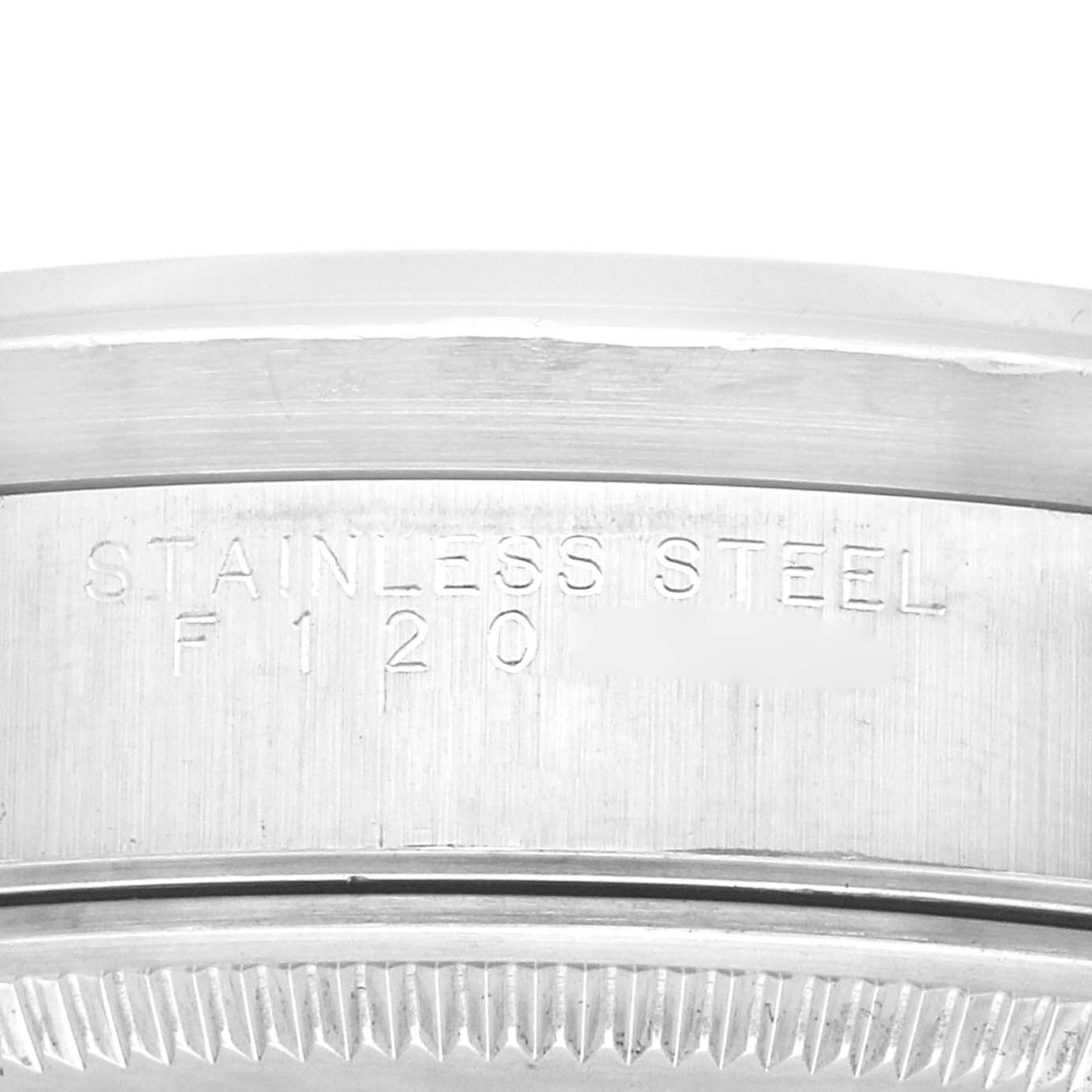 The image shows a close-up of the case back and bezel edge of a Rolex Air-King 14010 Men's Stainless Steel Silver Dial 14010 Men's Stainless Steel Silver Dial watch, highlighting the "STAINLESS STEEL" engraving.