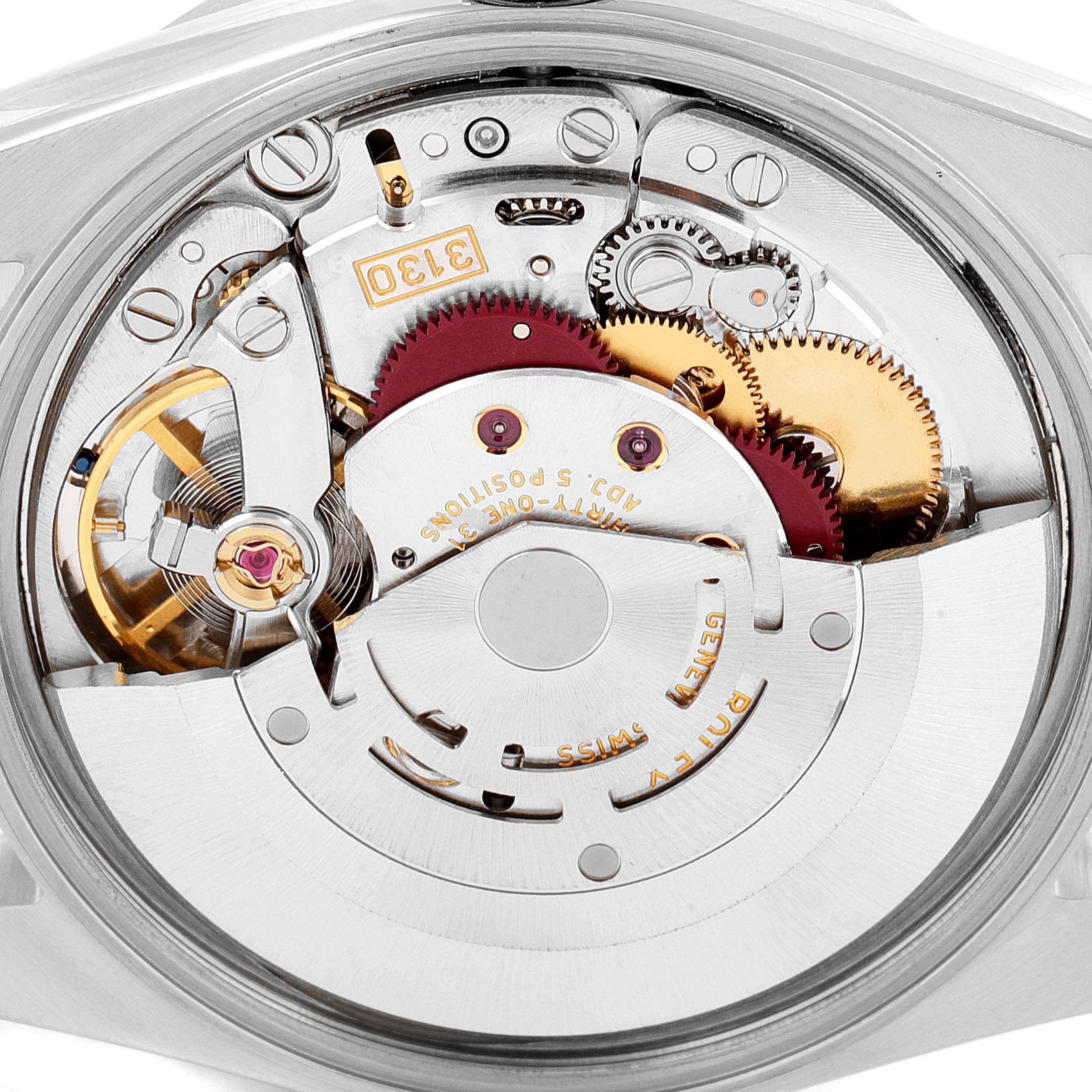 This image shows a close-up of the internal mechanism of a Rolex Air-King 14010 Men's Stainless Steel Silver Dial 14010 Men's Stainless Steel Silver Dial watch, highlighting the gears and intricate components.