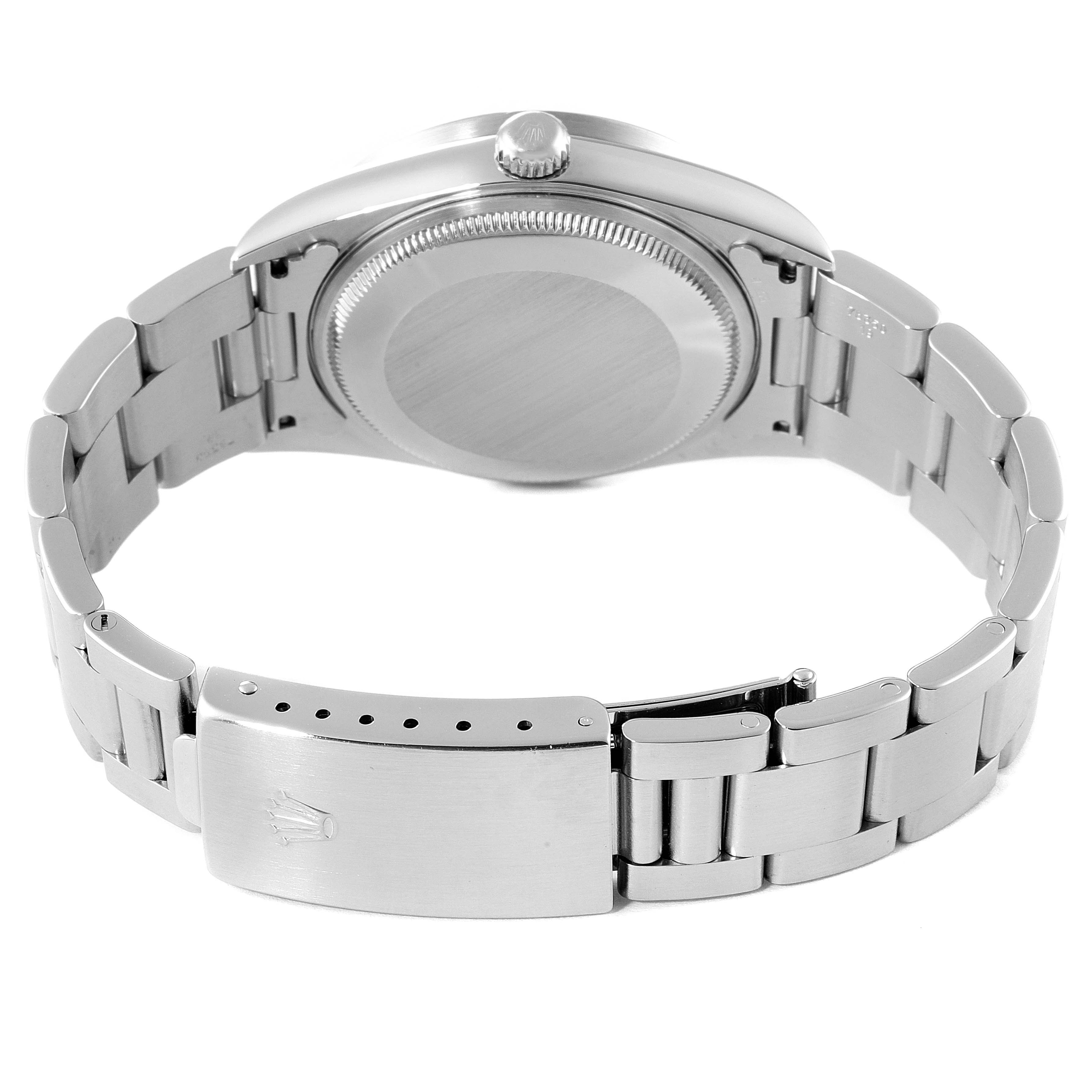 The image shows a Rolex Air-King 14010 Men's Stainless Steel Silver Dial 14010 Men's Stainless Steel Silver Dial watch from the back, including its closed stainless steel clasp and bracelet.