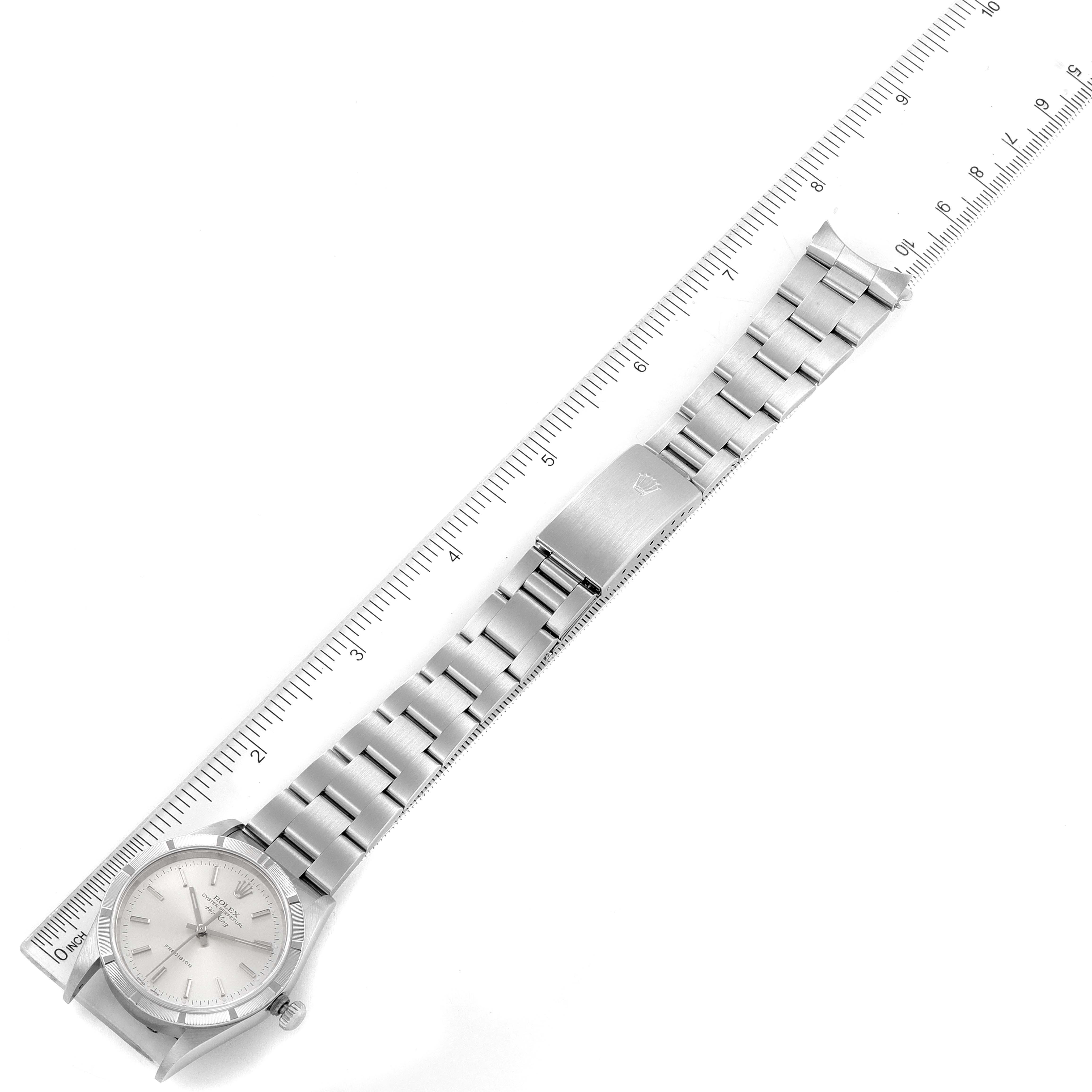 The image shows a top view of a Rolex Air-King 14010 Men's Stainless Steel Silver Dial 14010 Men's Stainless Steel Silver Dial watch laid flat next to a ruler, displaying its entire bracelet and clasp.