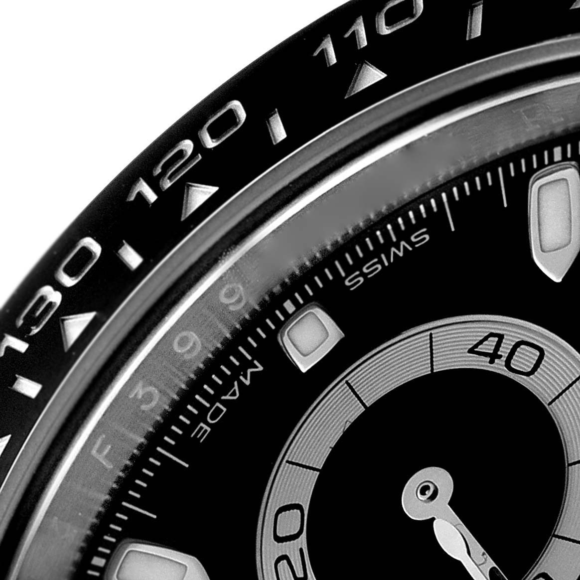 This image shows a close-up of the bezel and a portion of the dial of a Rolex Daytona 116500 Men
s Stainless Steel Black Dial 116500 Men
s Stainless Steel Black Dial watch, highlighting the tachymeter scale.