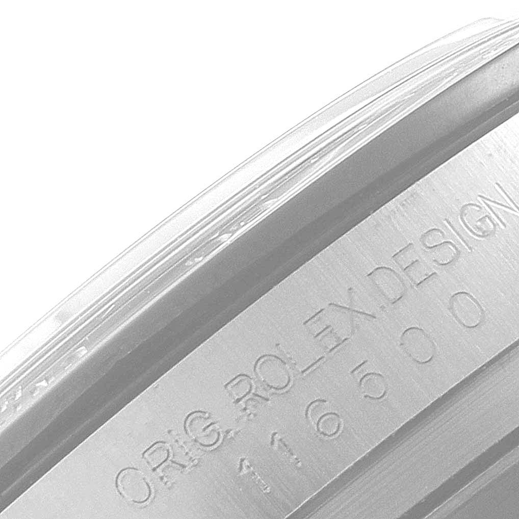 This image shows a close-up of the side case of a Rolex Daytona 116500 Men
s Stainless Steel Black Dial 116500 Men
s Stainless Steel Black Dial watch displaying the engraved text "ORIG ROLEX DESIGN 116500."