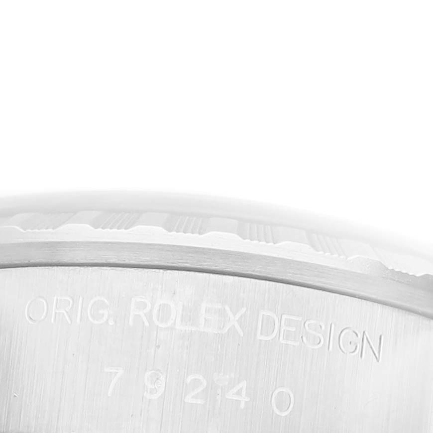 The image shows a close-up angle of the side of a Rolex Date 79240 Women's Stainless Steel Black Dial 79240 Women's Stainless Steel Black Dial model, featuring its engraved design details.