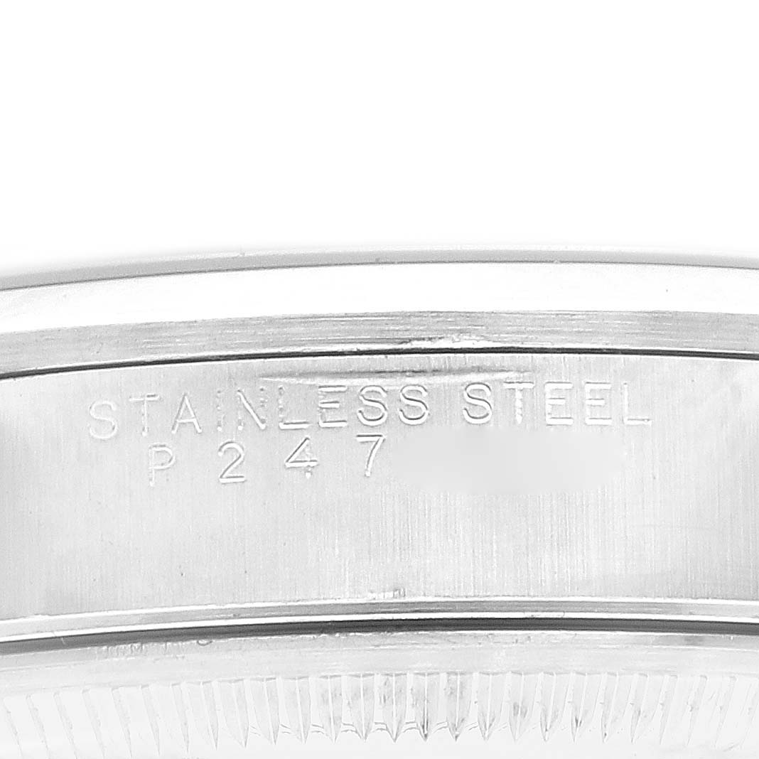 The image shows a close-up of the stainless steel casing of a Rolex Date 15200 Men's Stainless Steel Blue Dial 15200 Men's Stainless Steel Blue Dial model watch with "STAINLESS STEEL P 247" engraved on it.