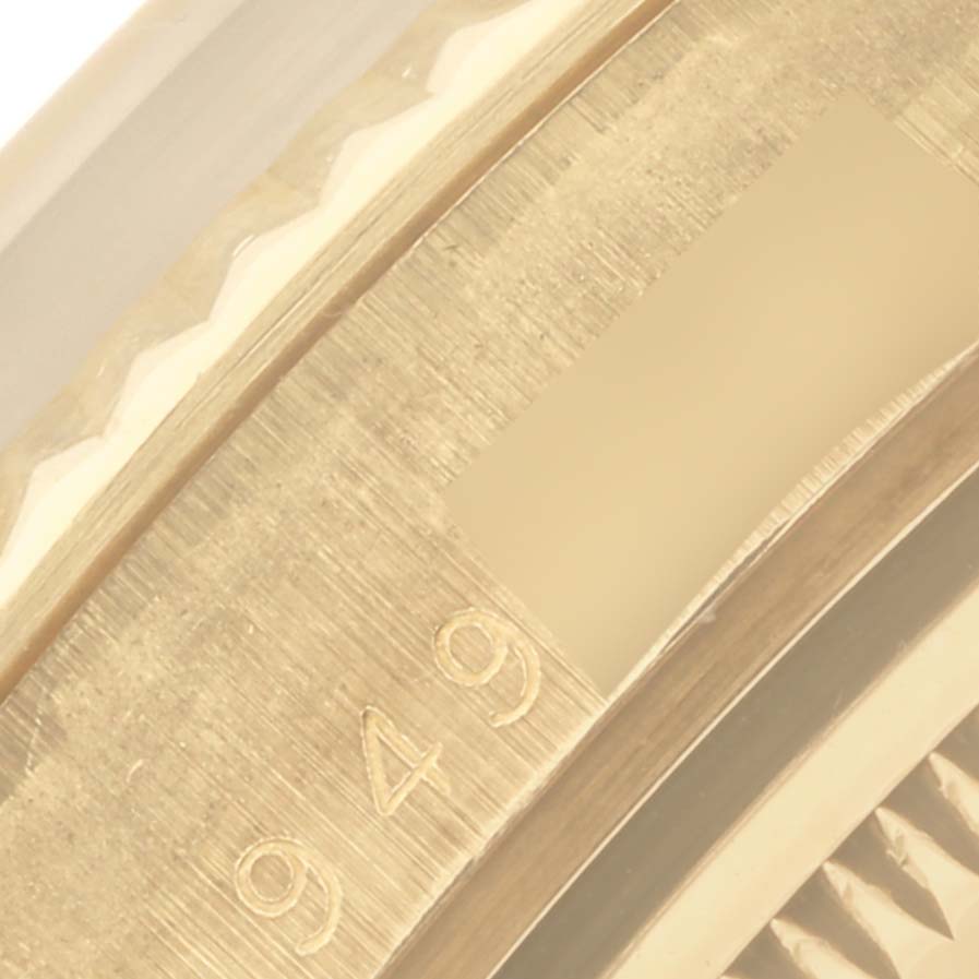 The image shows a close-up of the edge and engraved numbers on the bezel of a Rolex Date 15037 Men's Yellow Gold Champagne Dial 15037 Men's Yellow Gold Champagne Dial model watch.