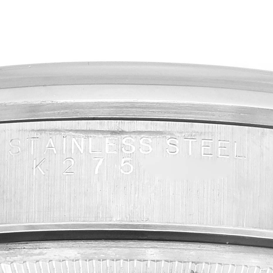 The image shows a close-up of the case back of a Rolex Date 15200 Men's Stainless Steel Silver Dial 15200 Men's Stainless Steel Silver Dial model watch with "STAINLESS STEEL" and serial number inscription.