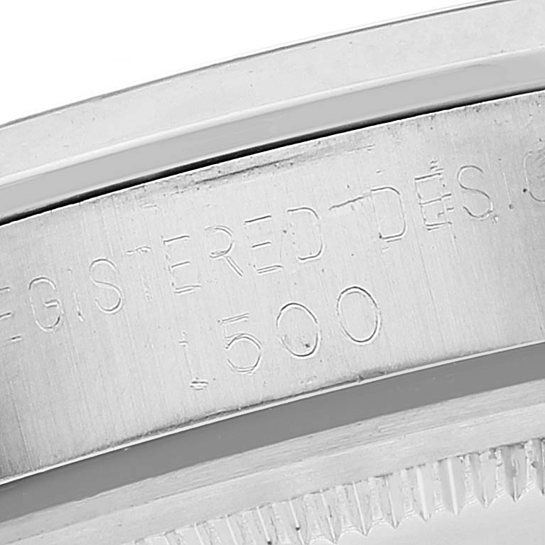 A close-up of the engraved outer edge of the Rolex Vintage Collection 1500 Men
s Stainless Steel Silver Dial 1500 Men
s Stainless Steel Silver Dial watch, specifically showing the text "REGISTERED DESIGN 1500."