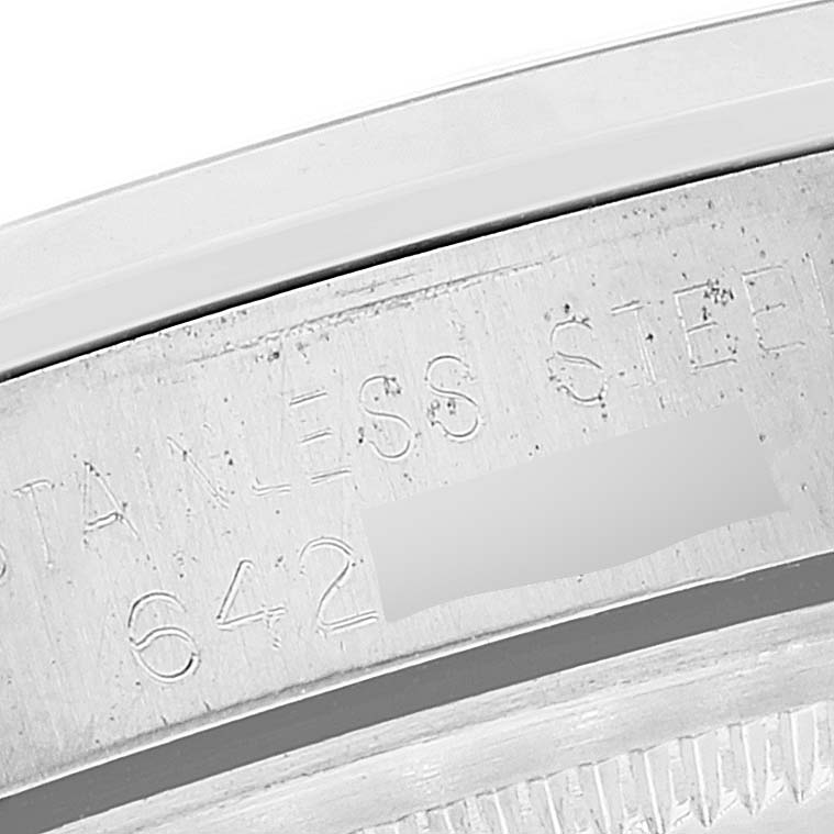 This image shows a close-up of the engraved serial number and "STAINLESS STEEL" text on the caseback of a Rolex Vintage Collection 1500 Men
s Stainless Steel Silver Dial 1500 Men
s Stainless Steel Silver Dial watch.