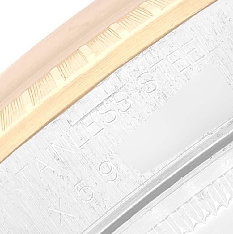 This close-up image of a Rolex Date 15223 Men's Steel and Gold (two tone) Champagne Dial 15223 Men's Steel and Gold (two tone) Champagne Dial model shows part of the bezel and the engraved text on the watch case.