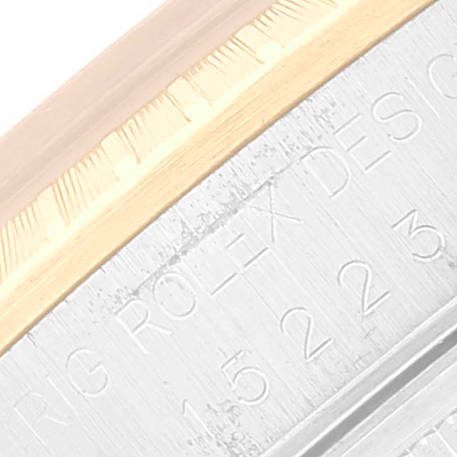 This is a close-up shot of the side of a Rolex Date 15223 Men's Steel and Gold (two tone) Champagne Dial 15223 Men's Steel and Gold (two tone) Champagne Dial model, showing the engraved brand and design portion.